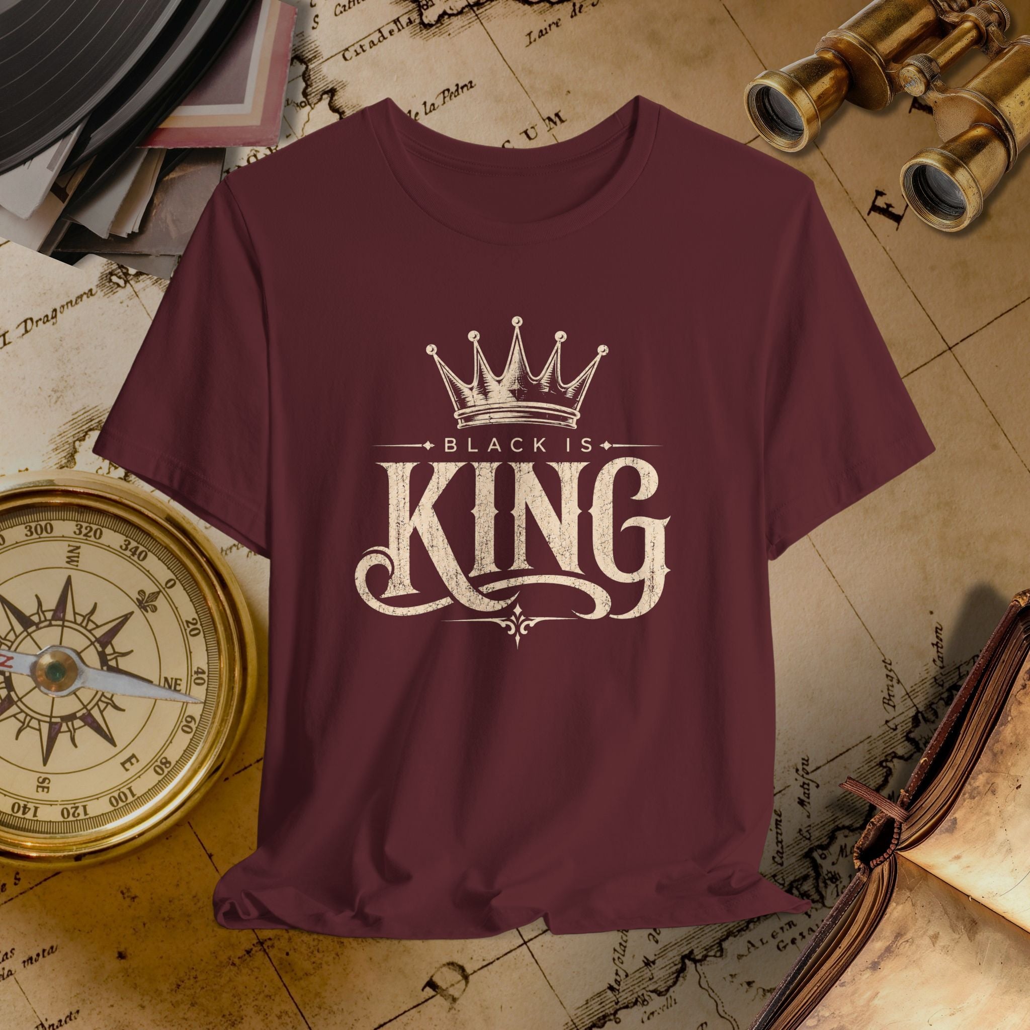 Maroon t-shirt with 'Black is King' design on a vintage map background