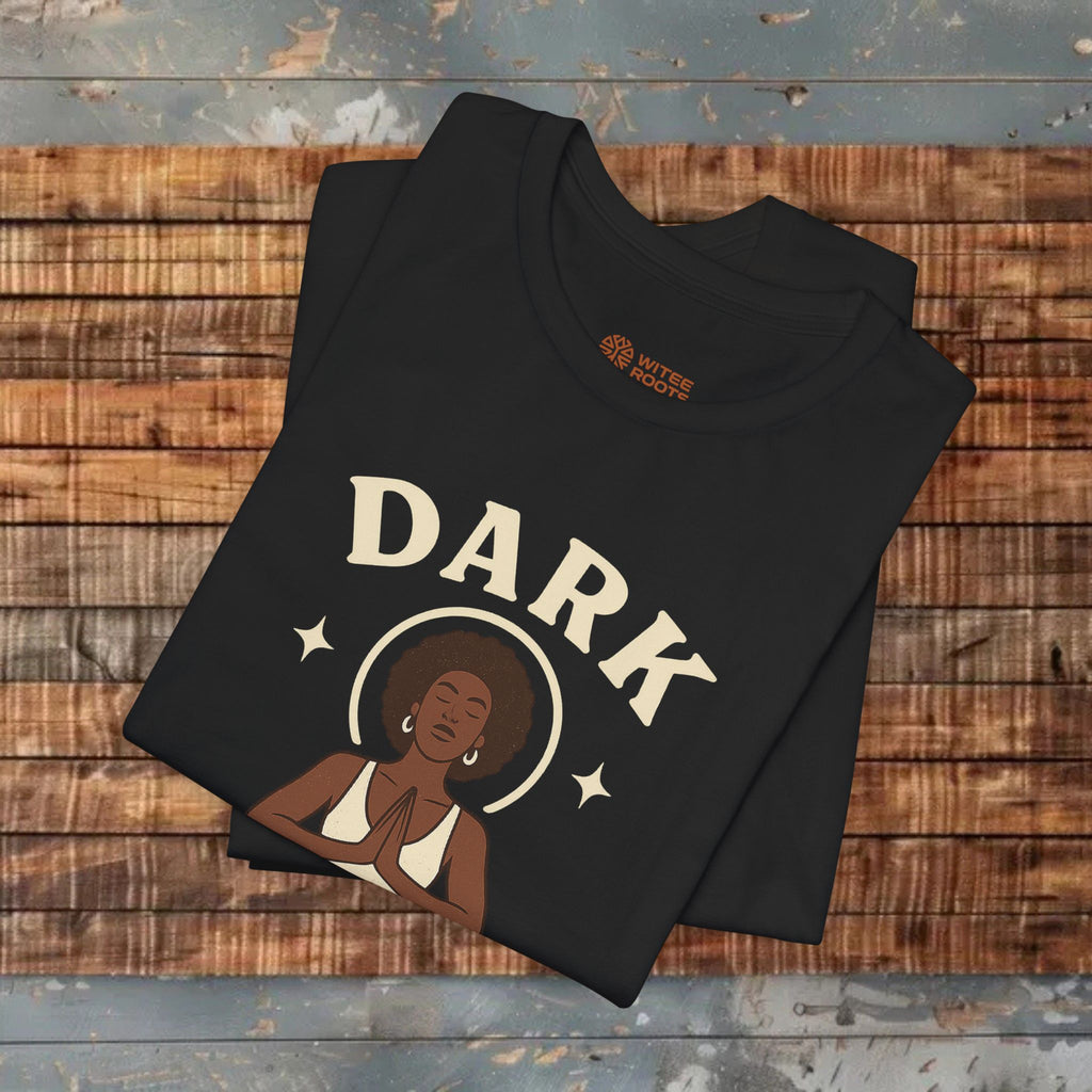 Black t-shirt with 'DARK' design on a wooden surface