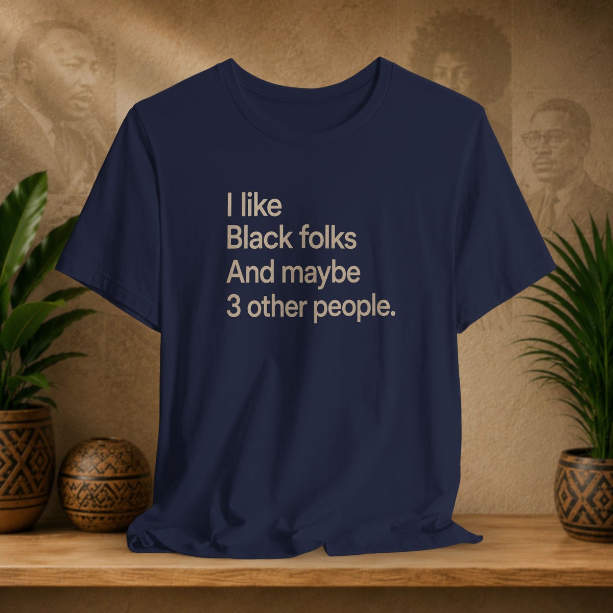 A navy blue graphic t-shirt with the text 'I like Black folks And maybe 3 other people.' printed in a light beige sans-serif font.