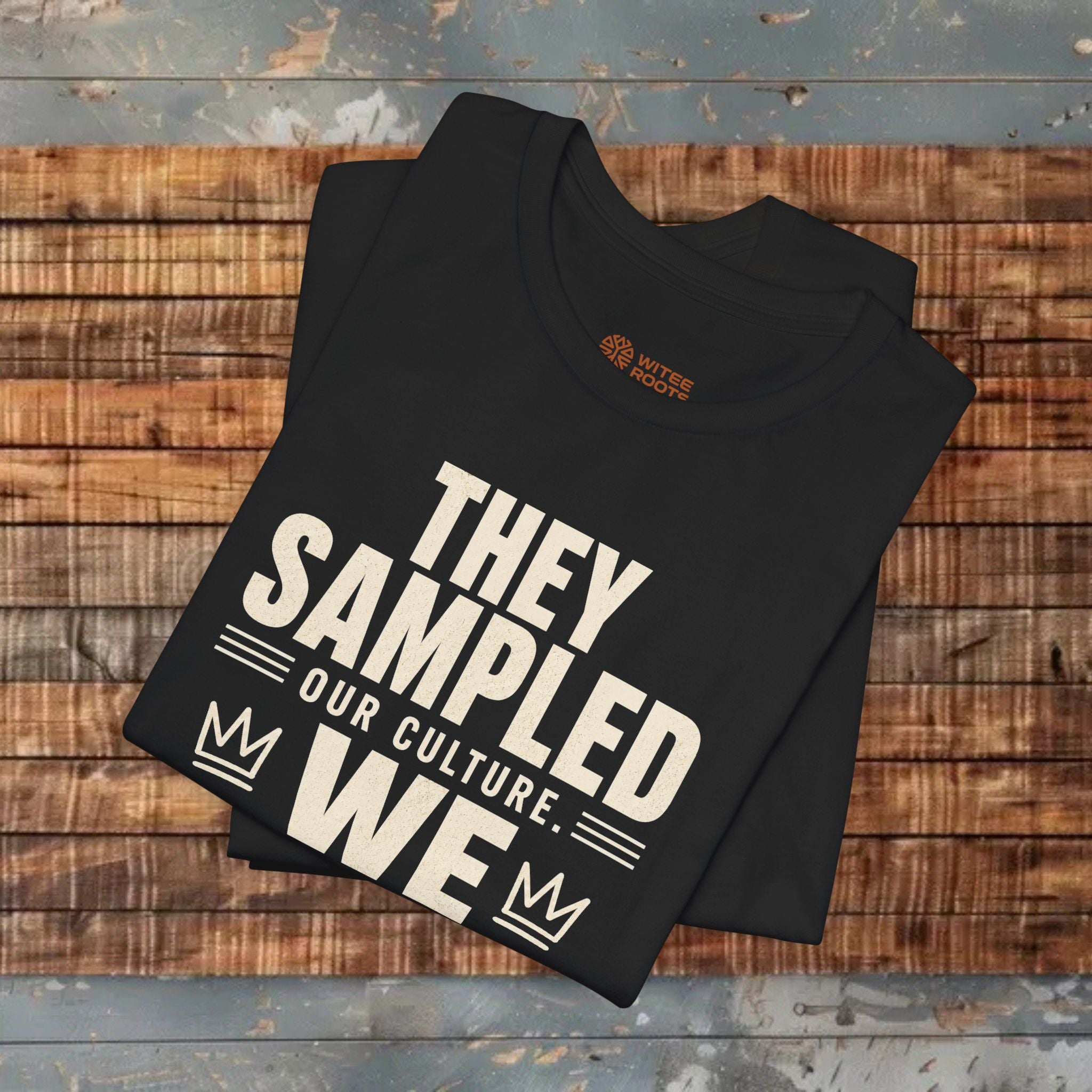 Black t-shirt with white text on a wooden surface