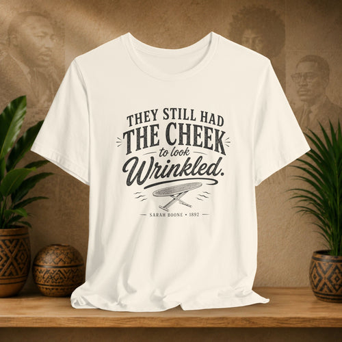 White t-shirt with text on a wooden surface with plants and a vintage-style background