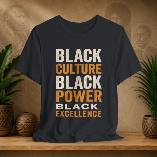 Black t-shirt with 'Black Culture, Black Power, Black Excellence' text on a wooden surface with plants and decorative items.