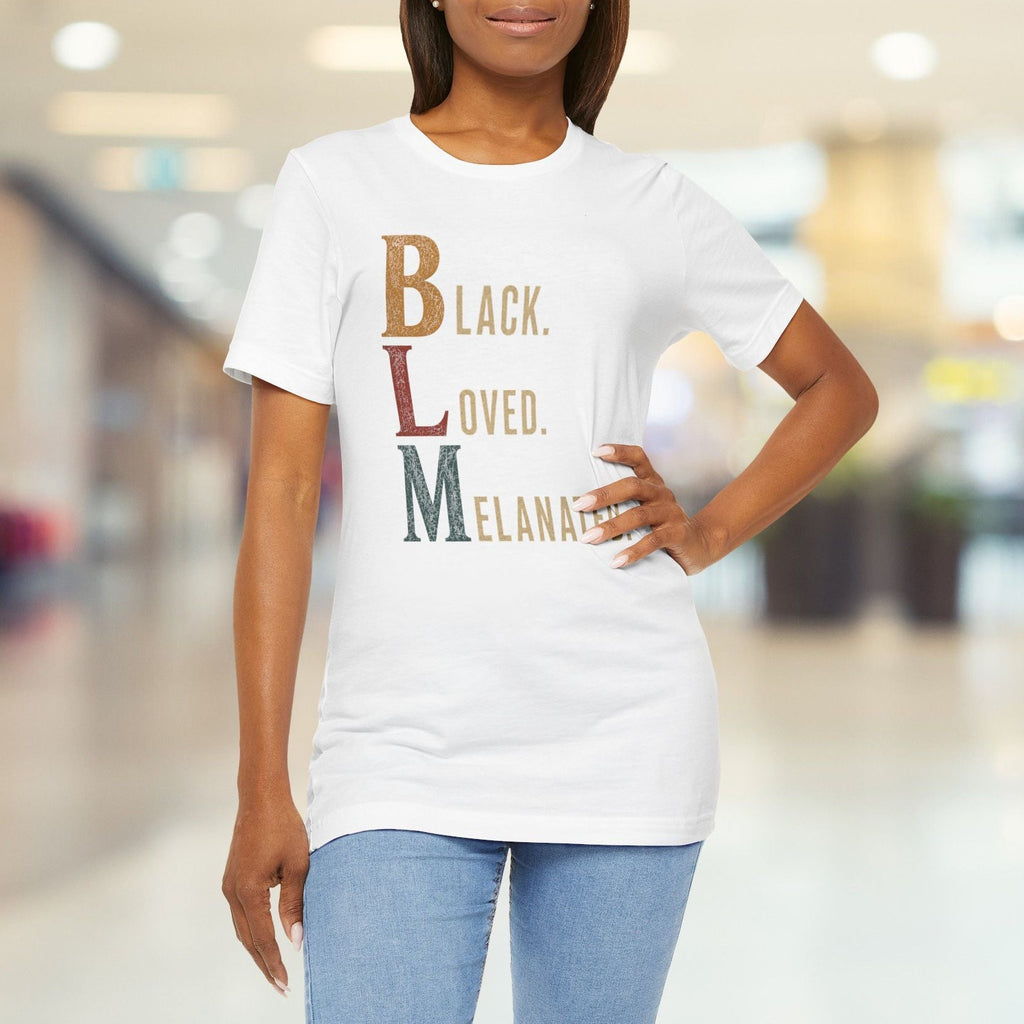 A woman wearing a white graphic t-shirt with the text 'Black. LOVED.