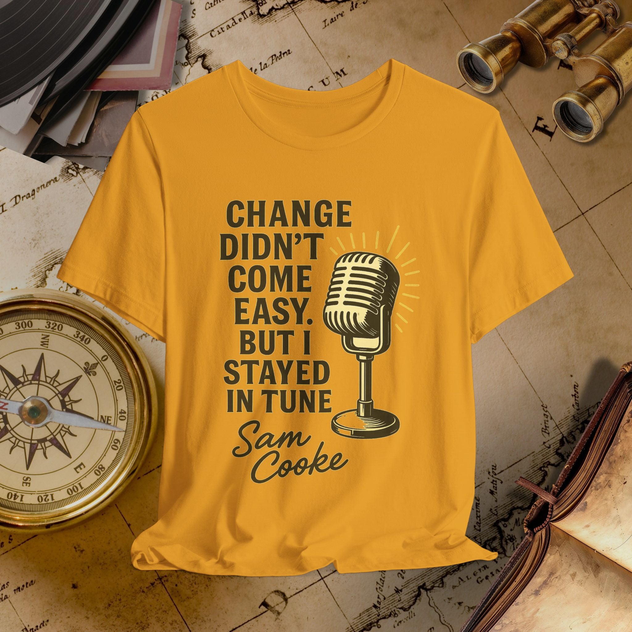 Mustard t-shirt with microphone graphic and text on a vintage background