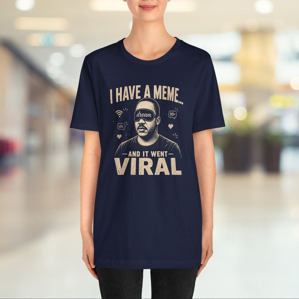 Person wearing a navy blue t-shirt with humorous text design in a blurred indoor setting
