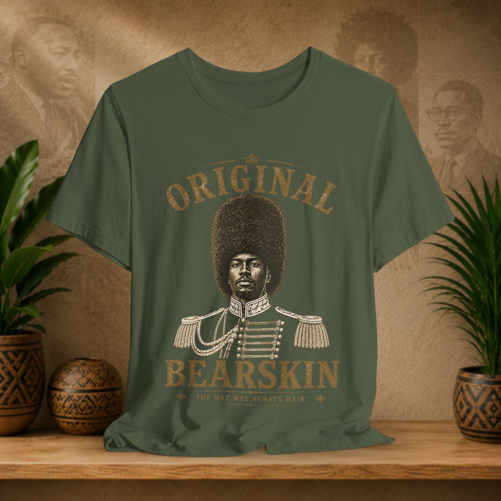 Green t-shirt with a graphic of a person wearing a bearskin hat and text on a wooden surface with plants.