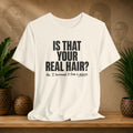 Beige t-shirt with humorous text on a wooden shelf with plants and a textured wall background