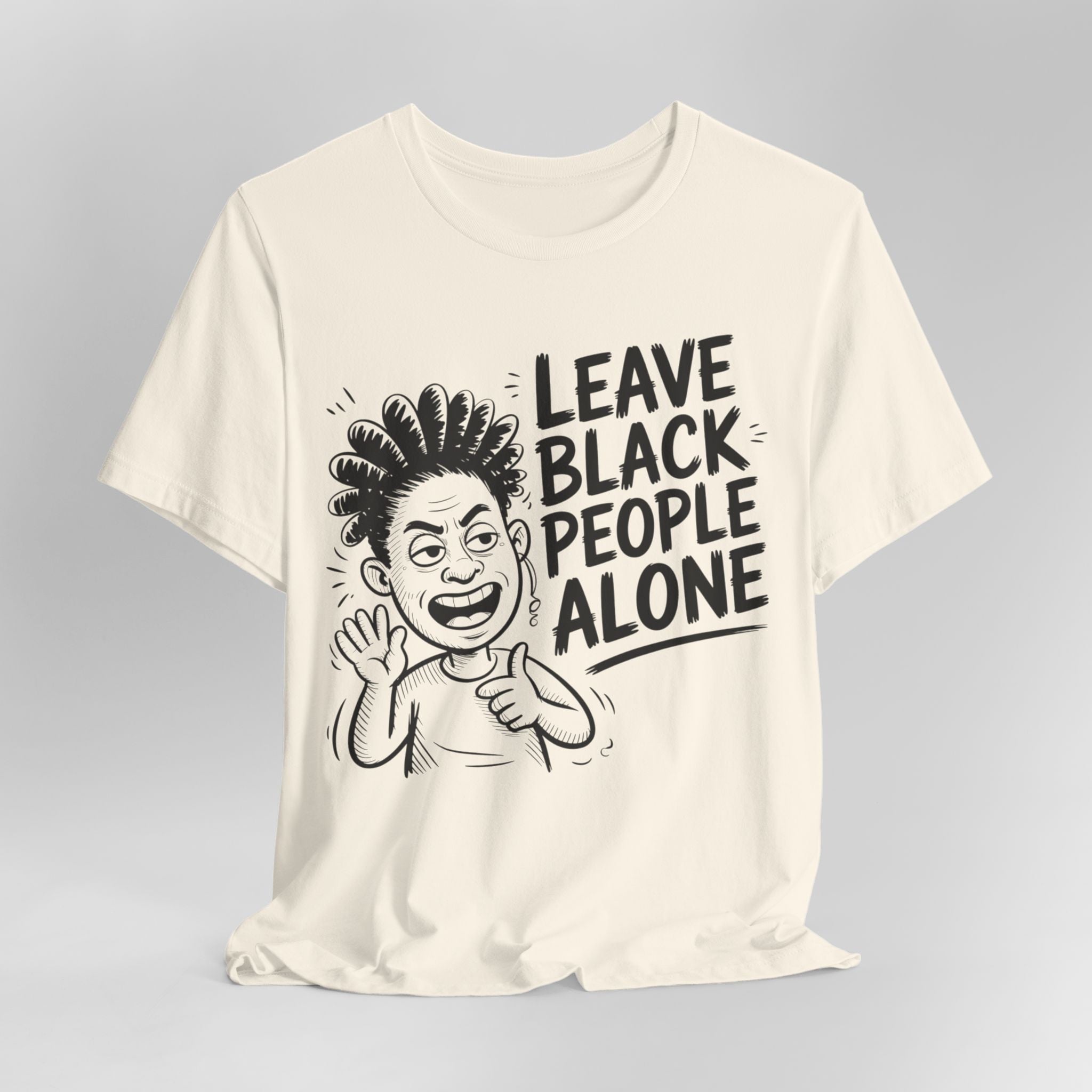 Cream t-shirt with a graphic and text 'Leave Black People Alone' on a gray background