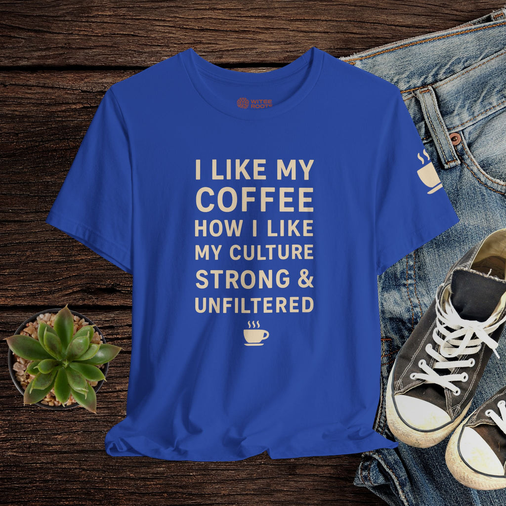 Blue t-shirt with text on a wooden surface with jeans and sneakers.