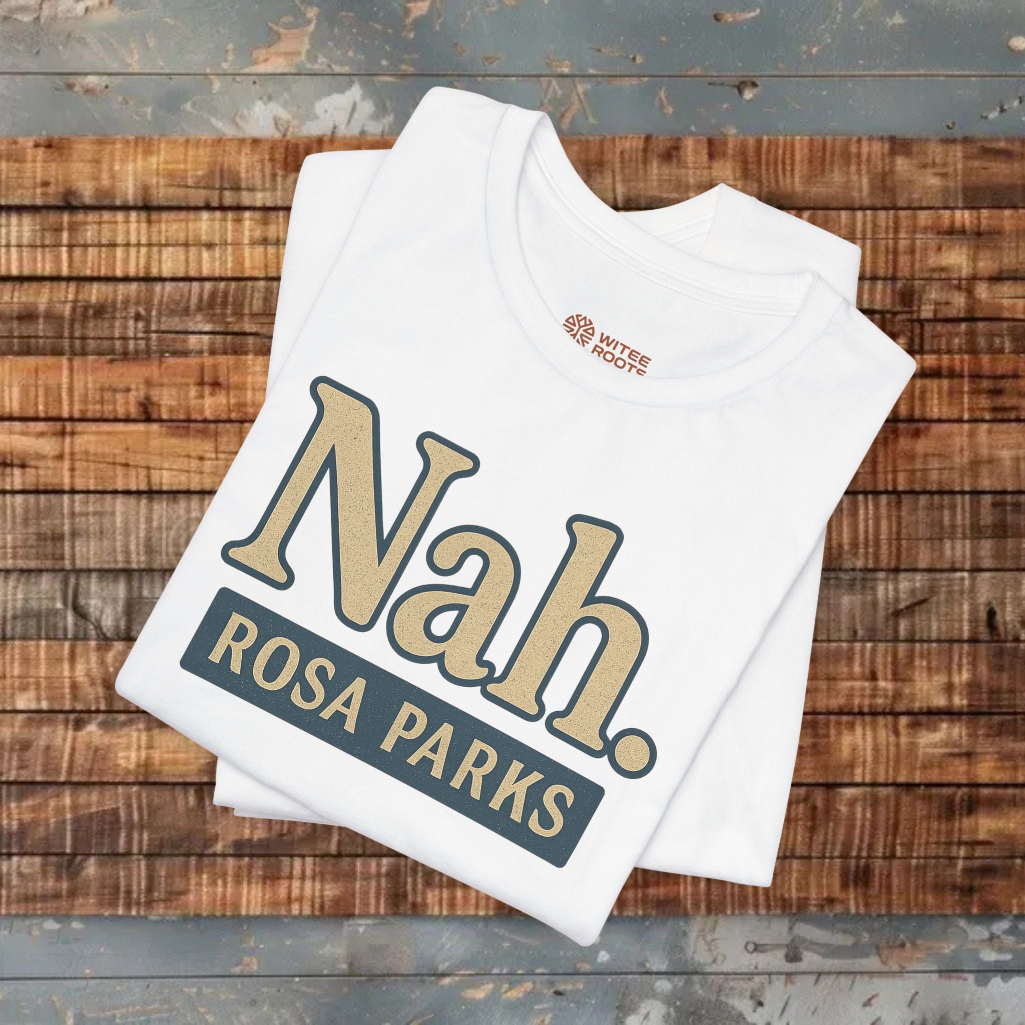 White t-shirt with 'Nah. ROSA PARKS' text on a wooden surface