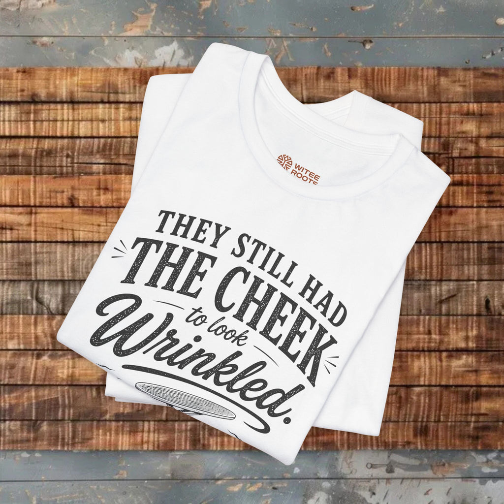 White t-shirt with printed text on a wooden surface