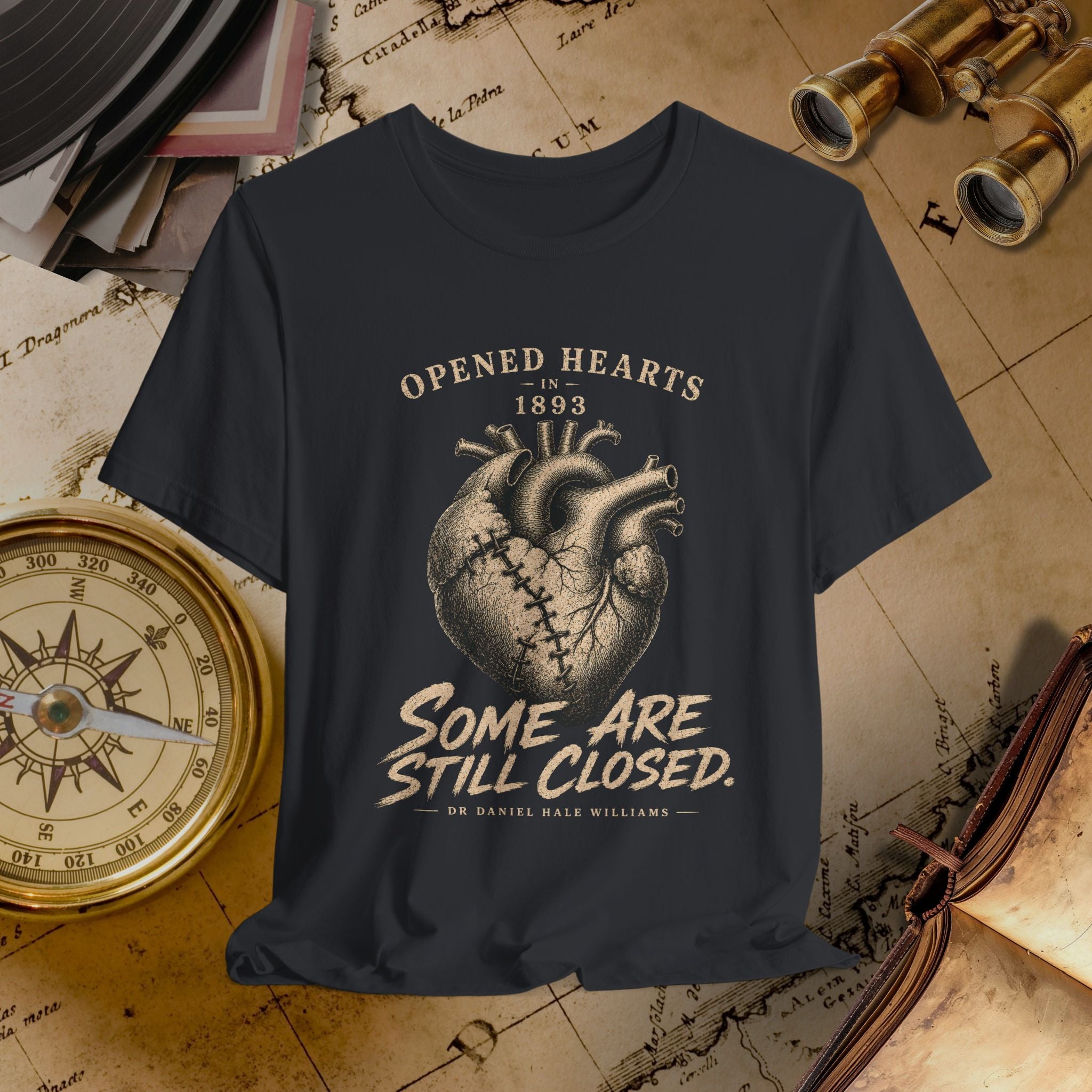 Black t-shirt with heart design and text on a vintage map background