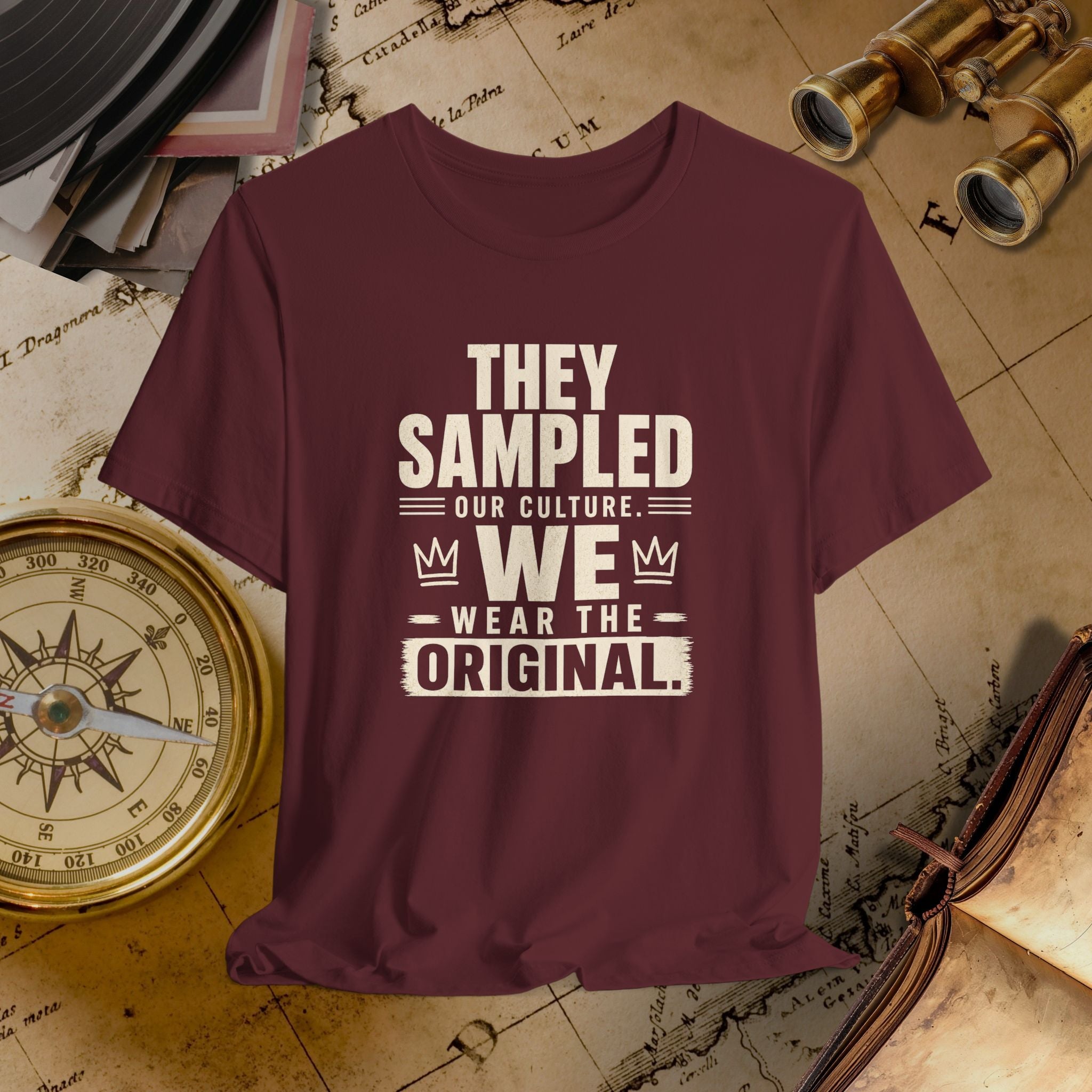 Maroon t-shirt with white text on a vintage map background