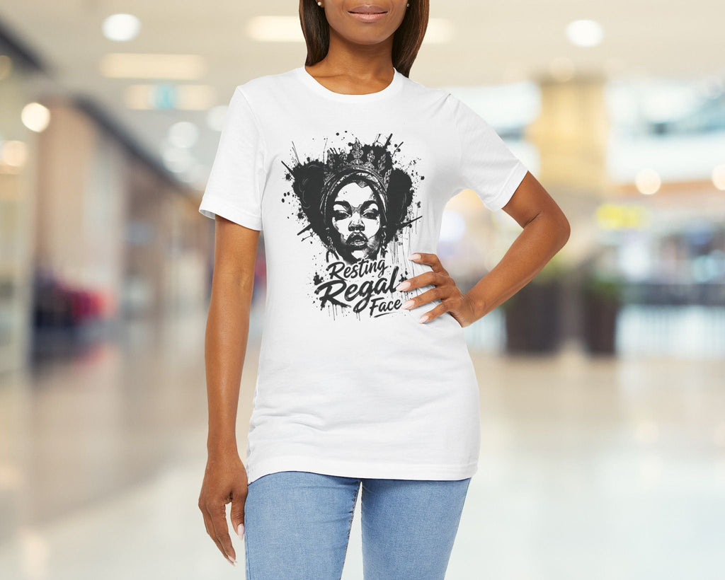 Woman wearing a white t-shirt with a graphic design in a blurred indoor setting