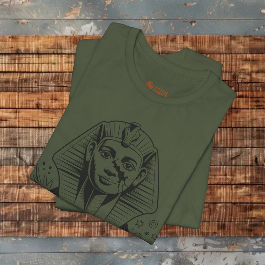 Folded green t-shirt with a graphic design on a wooden surface