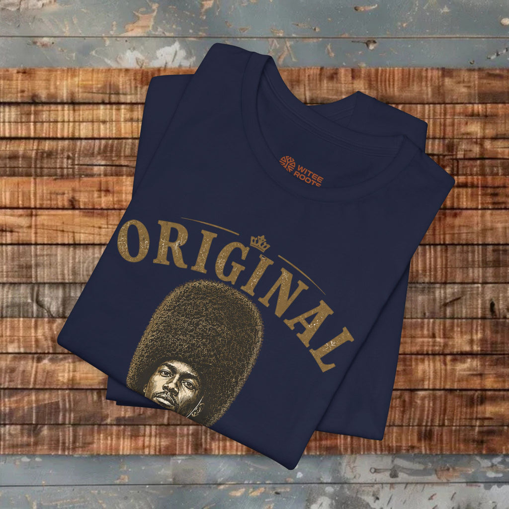 Folded navy blue t-shirt with 'ORIGINAL' and a graphic on a wooden surface