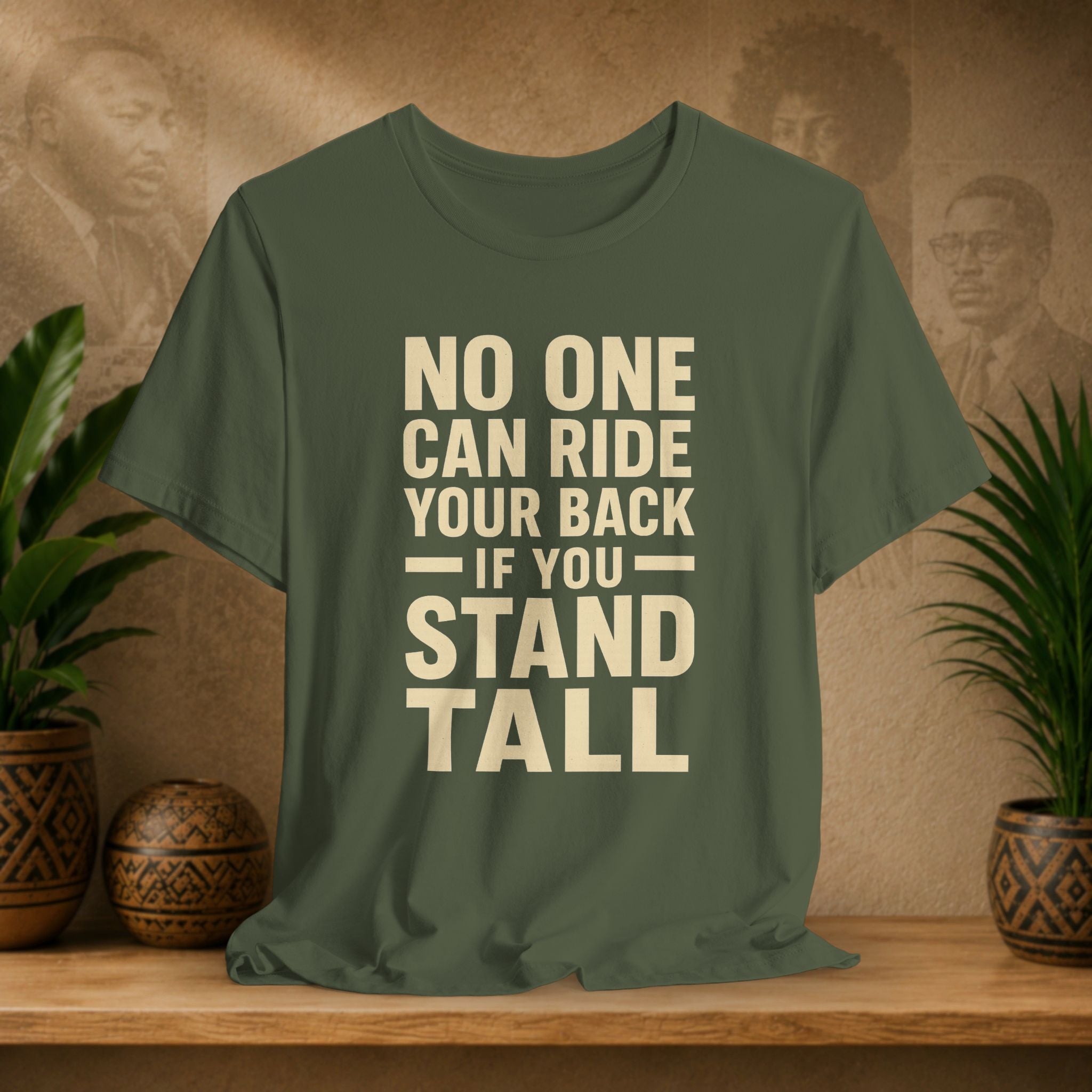 Green t-shirt with motivational quote on a wooden surface with decorative plants and background.