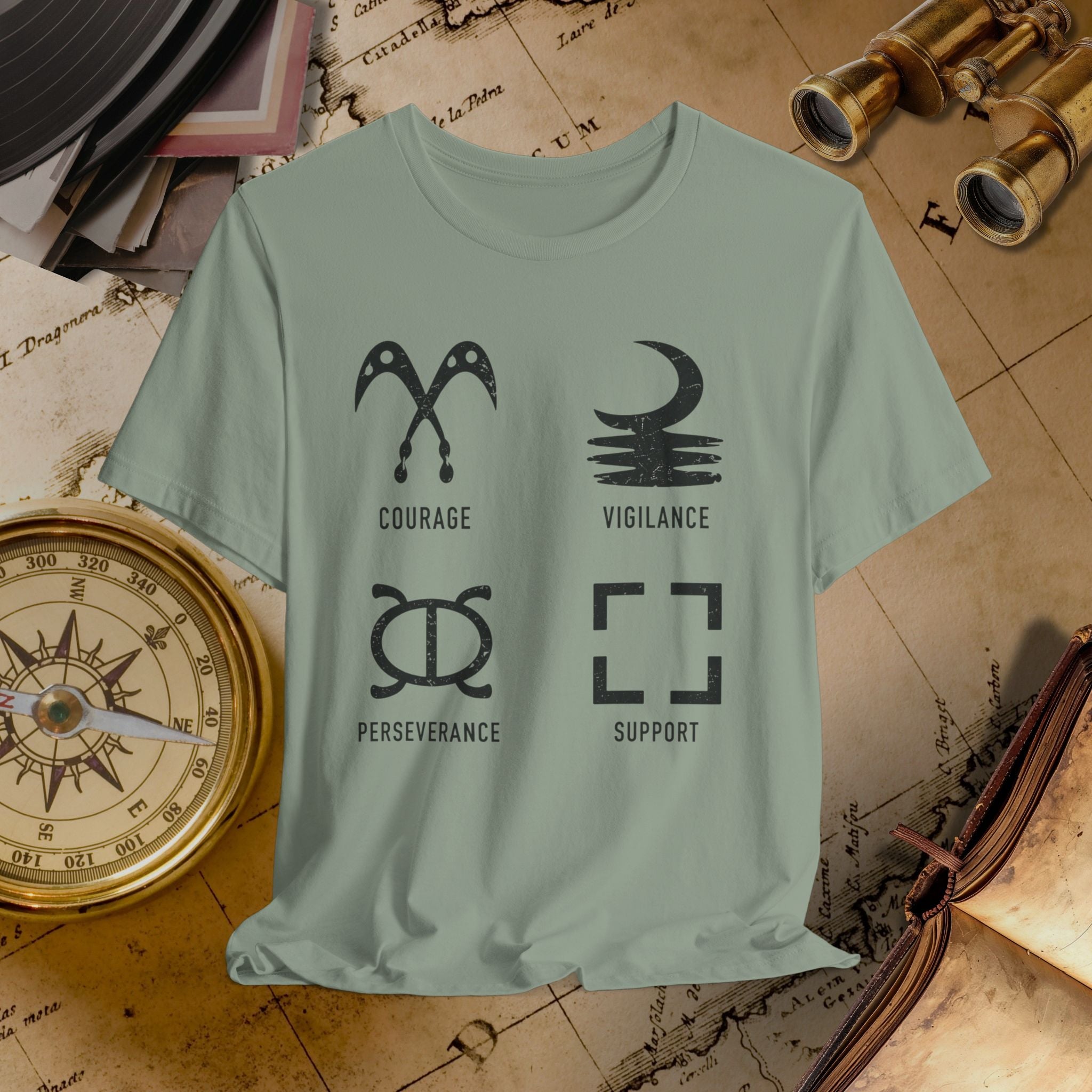 Light green t-shirt with symbols and text on a vintage map background