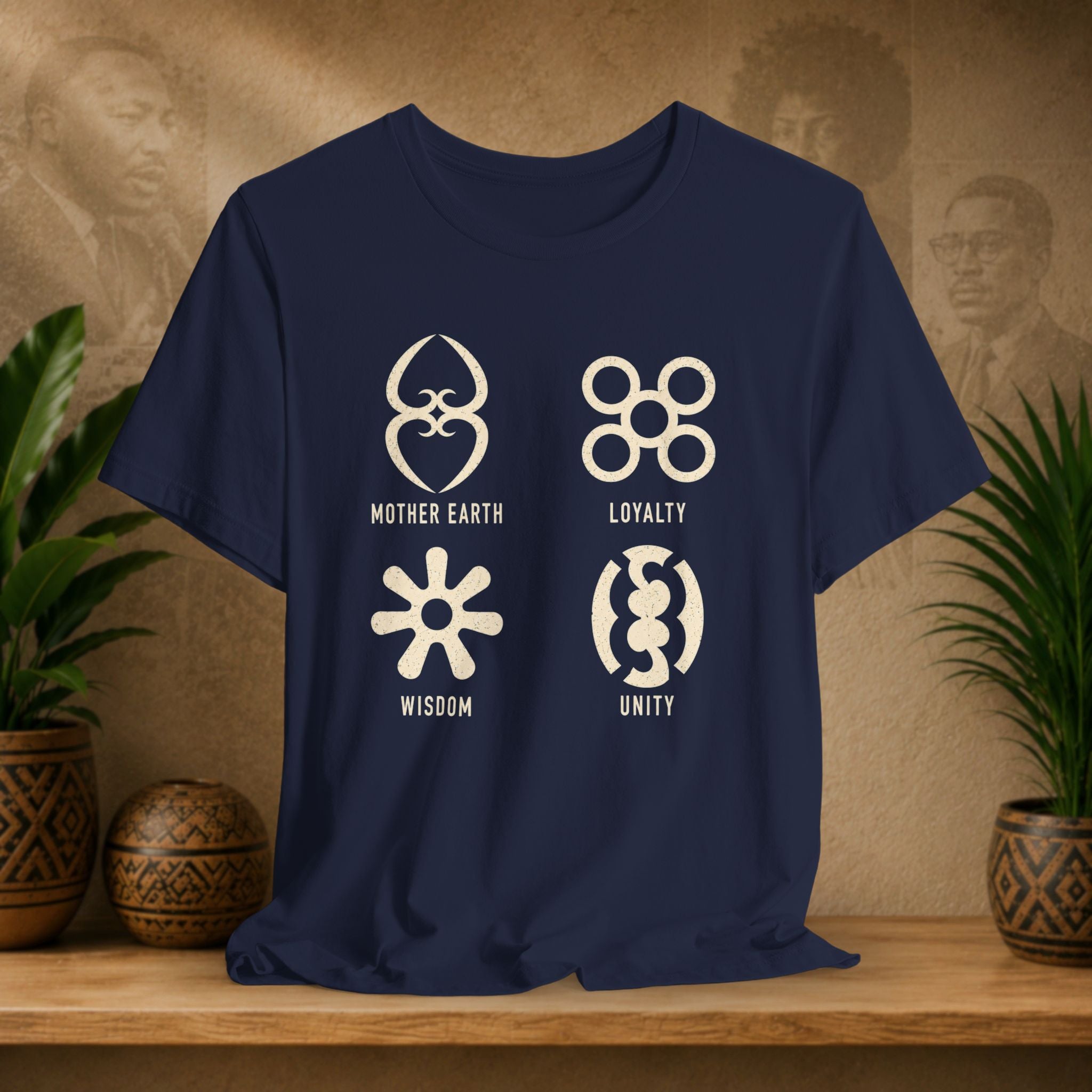 Navy blue t-shirt with white symbols and text on a wooden surface with plants and decorative items.