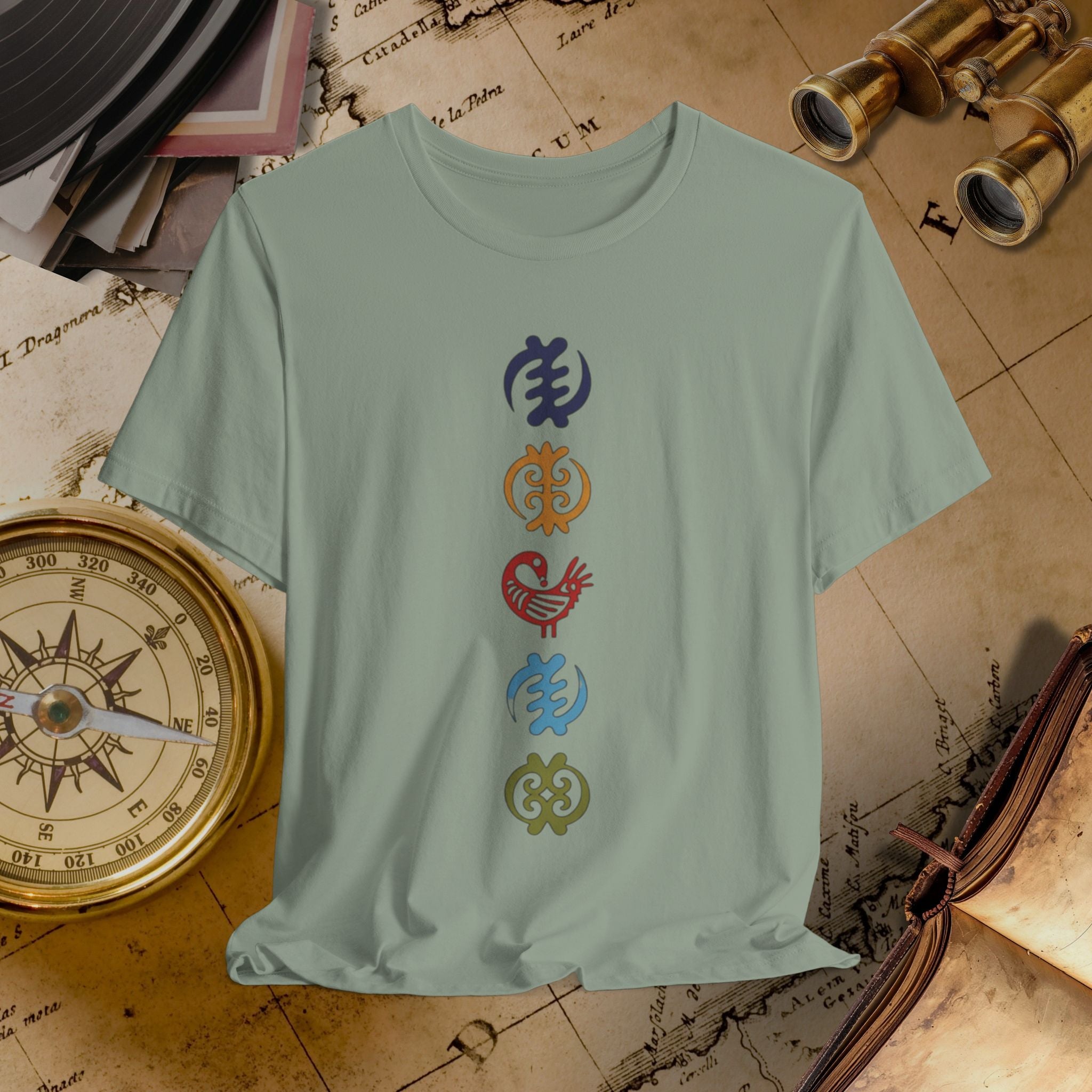 Light green t-shirt with colorful symbols on a vintage map background