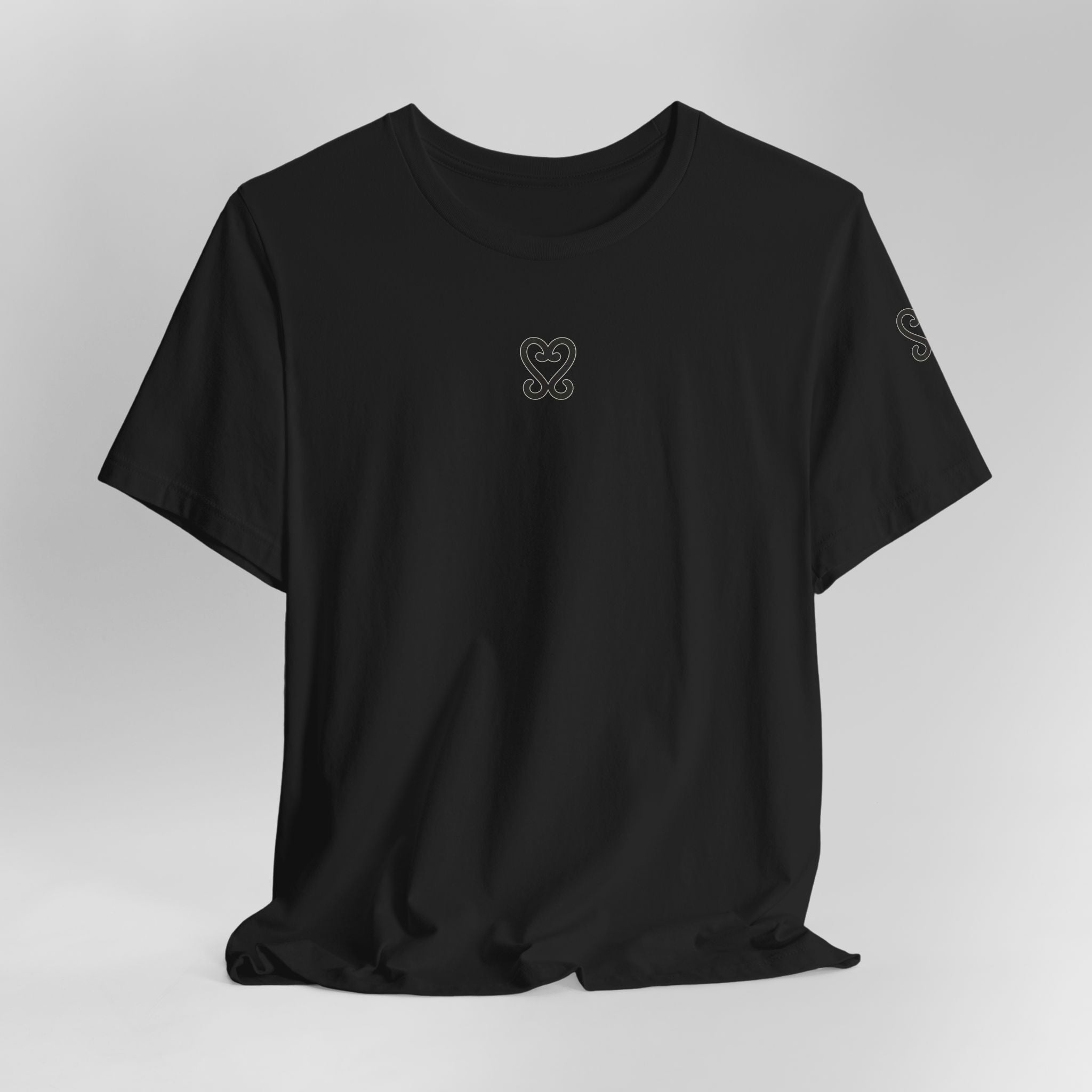 Black t-shirt with a small logo on a light gray background