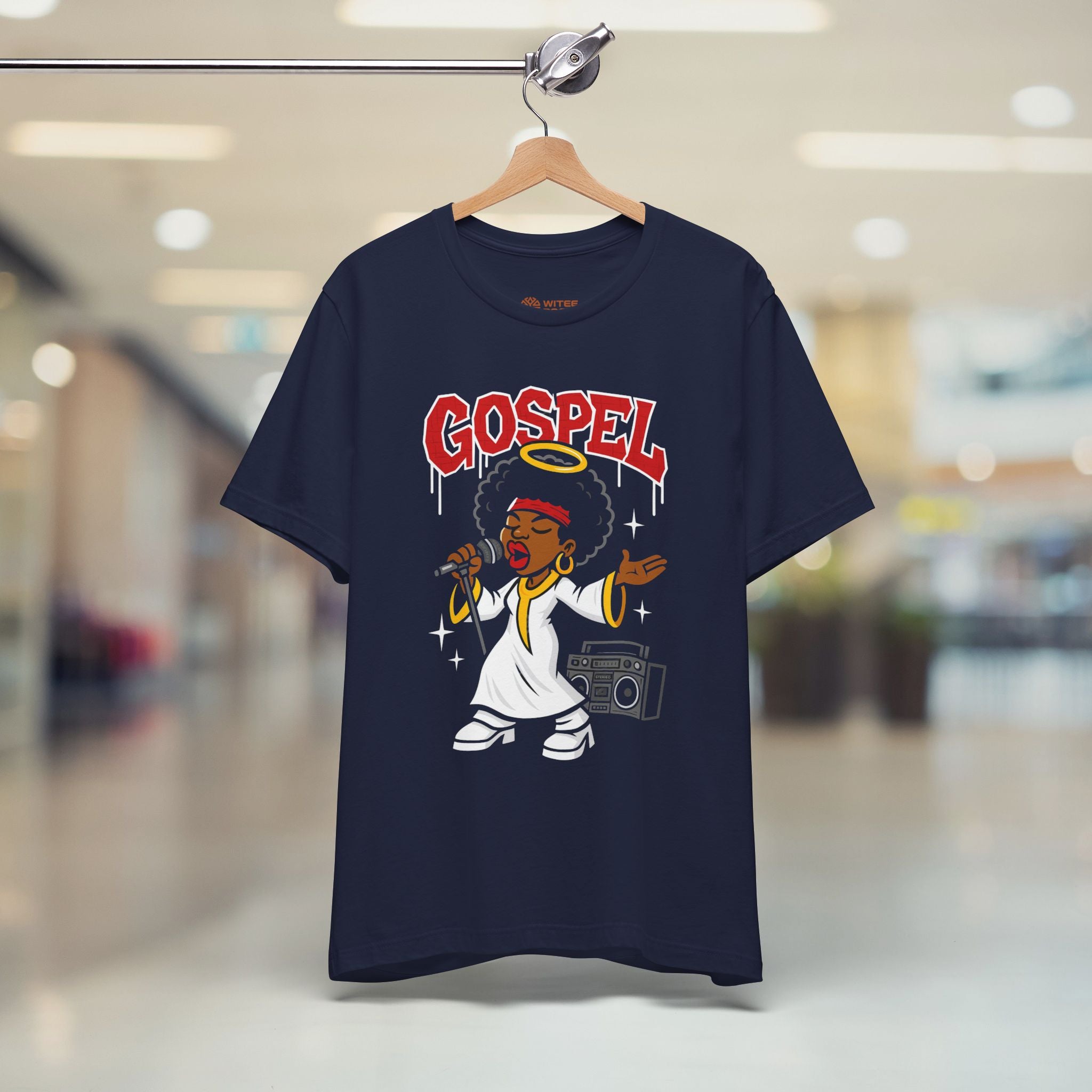 Navy blue t-shirt with 'Gospel' design on a hanger in a store.