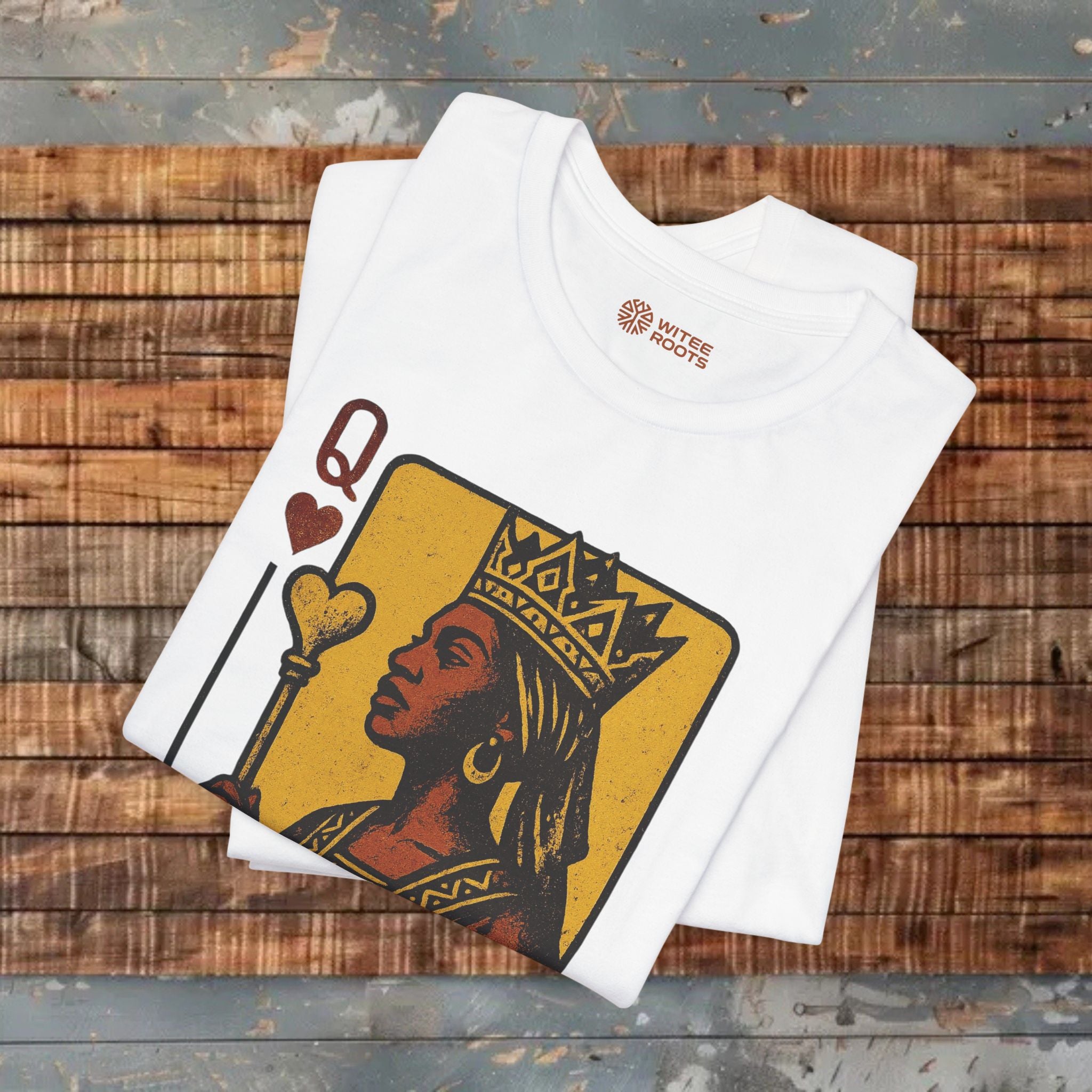 White t-shirt with a graphic design on a wooden surface
