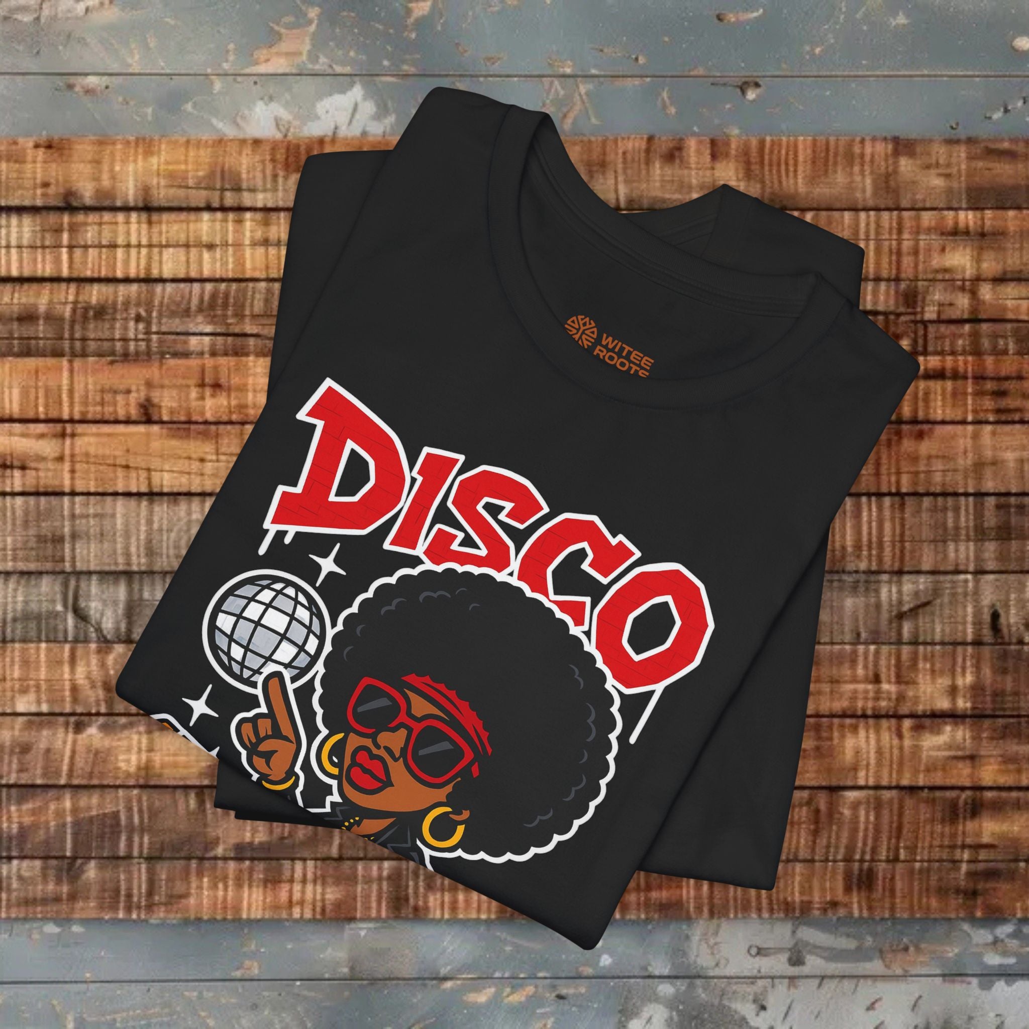 Black t-shirt with 'DISCO' design on a wooden surface