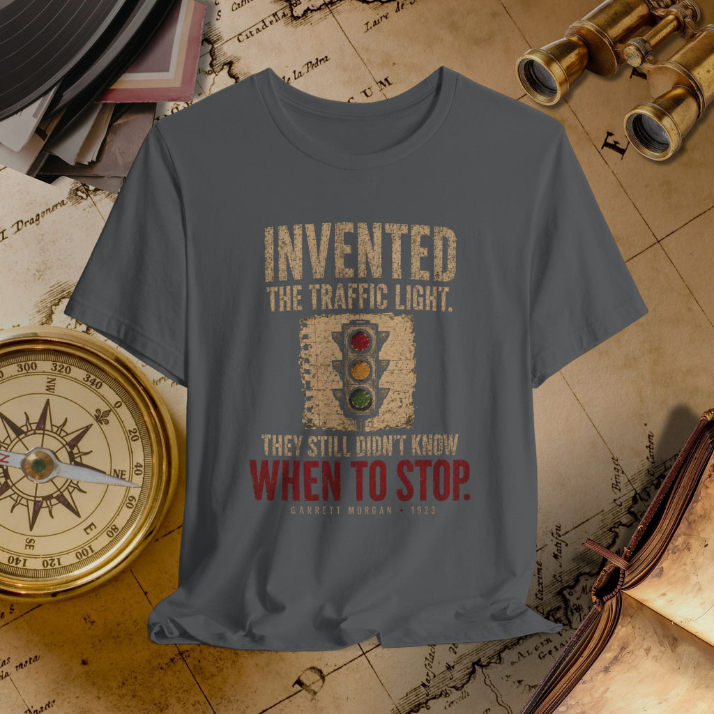 Gray t-shirt with traffic light graphic and text on a vintage map background