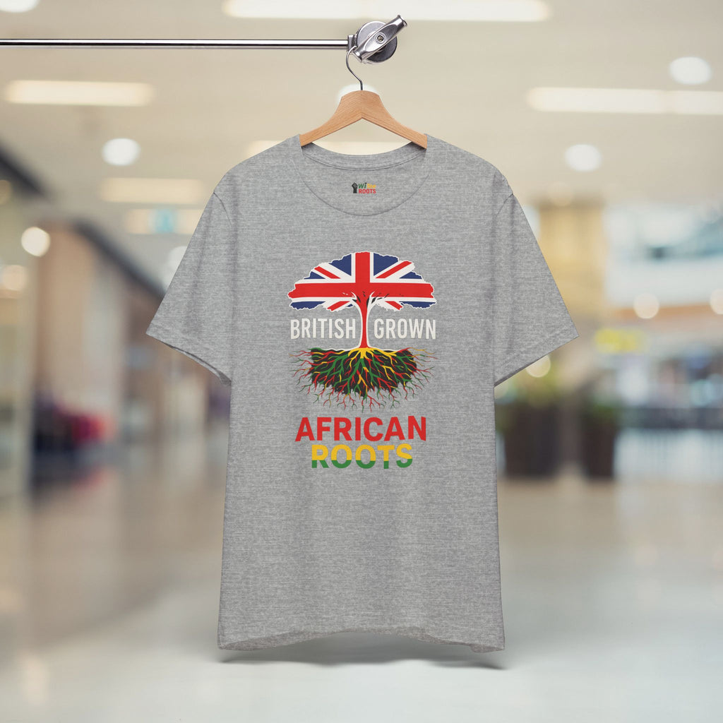 Gray t-shirt with a design of British flag and roots, text 'BRITISH GROWN AFRICAN ROOTS' on a hanger.
