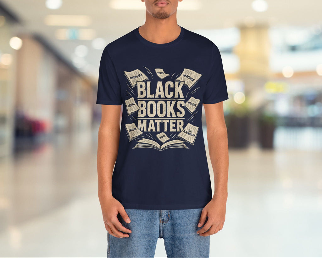 Person wearing a navy blue t-shirt with 'Black Books Matter' text in a mall setting