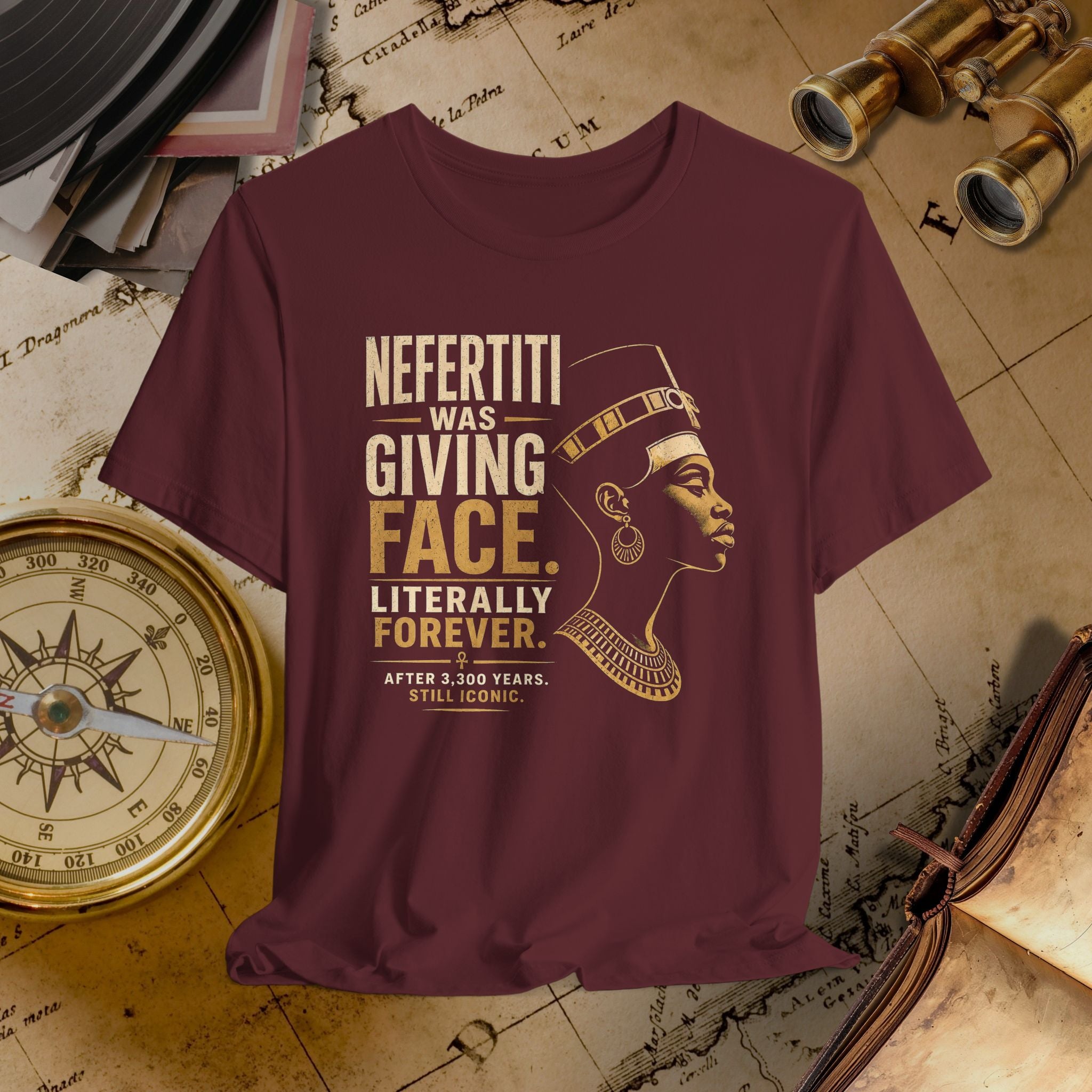 Maroon t-shirt with gold text and graphic of a historical figure on a vintage background.