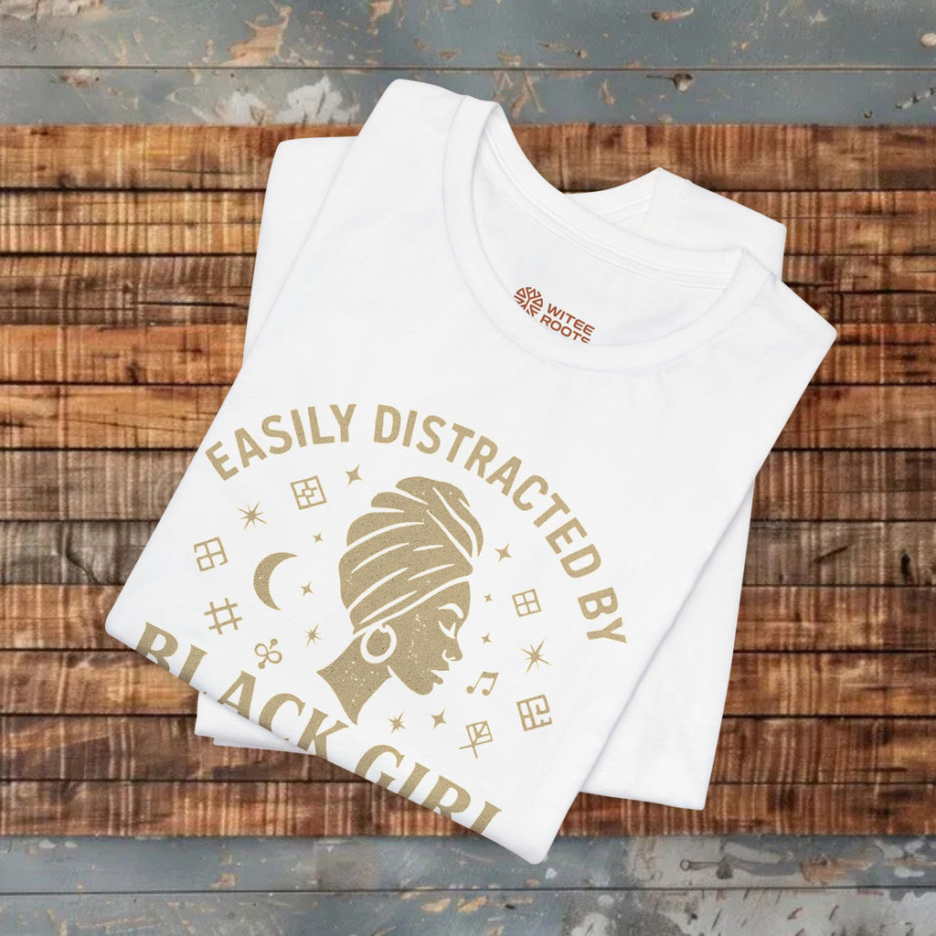 White tank top with 'Easily Distracted by Black Girl' text on a wooden surface