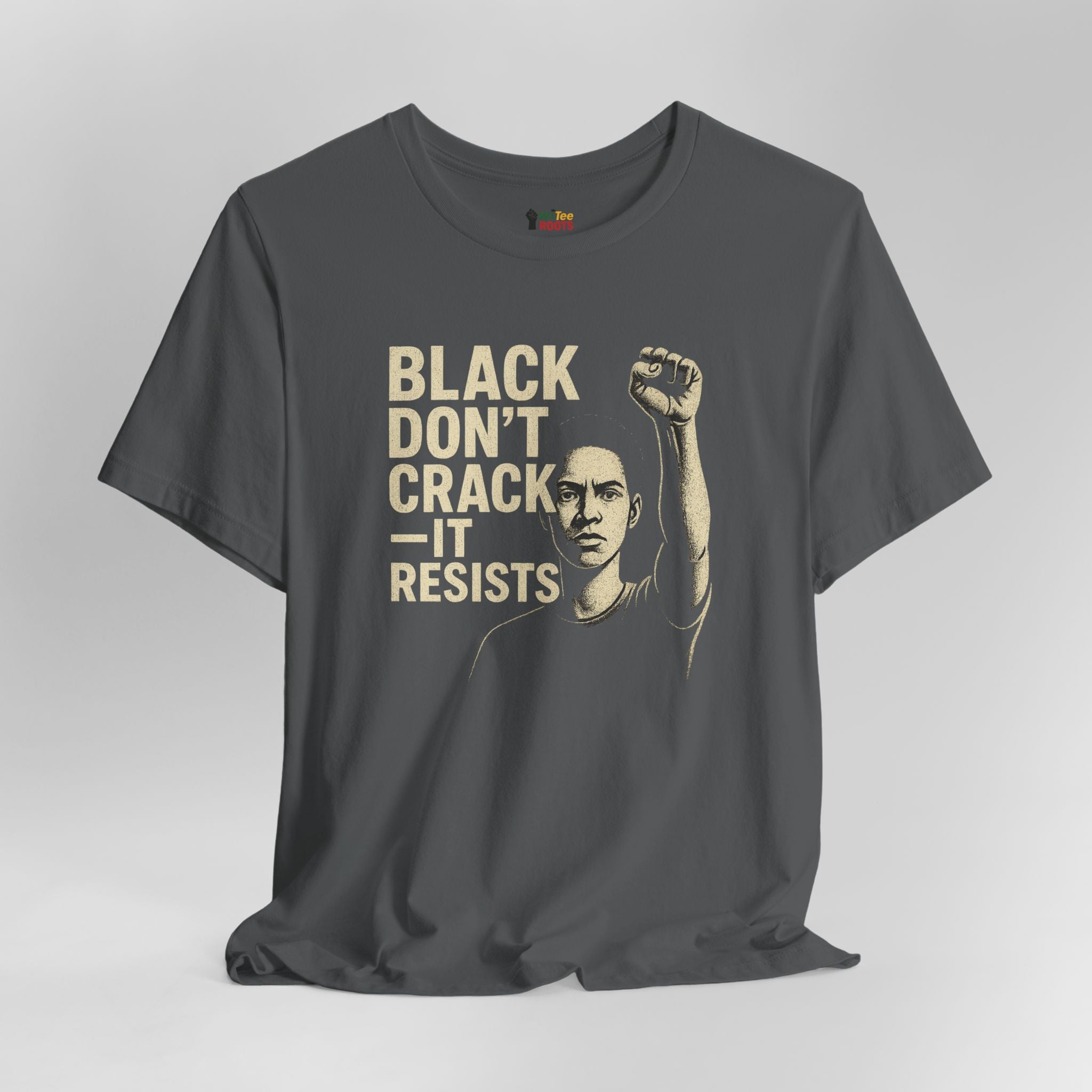 Gray t-shirt with graphic of a person raising a fist and text 'BLACK DON'T CRACK IT RESISTS' on a gray background