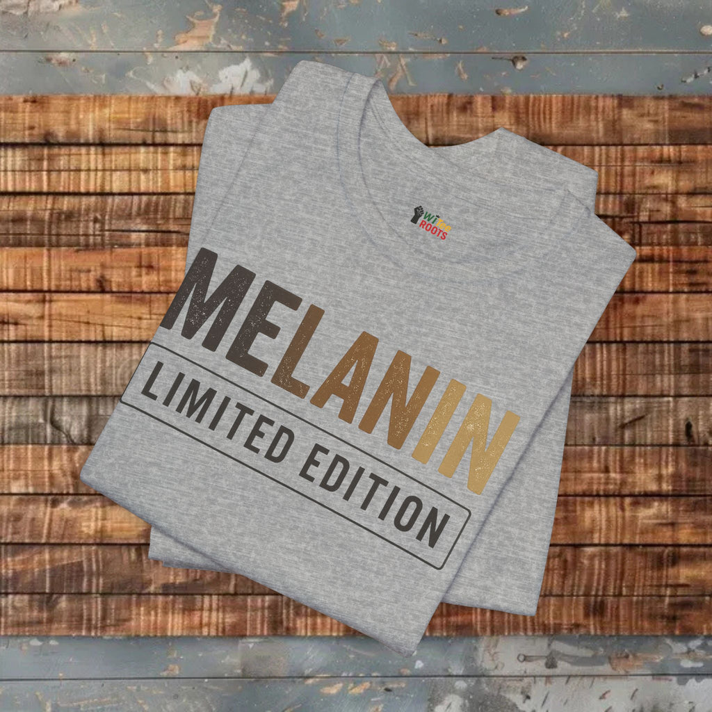 Gray t-shirt with 'Melanin Limited Edition' text on a wooden surface
