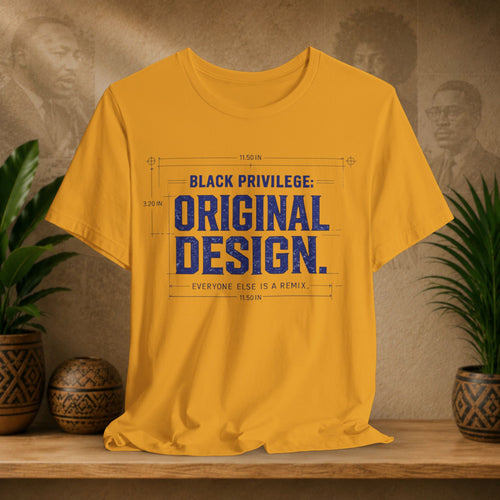 Mustard t-shirt with blue text on a wooden surface with plants and a textured wall background