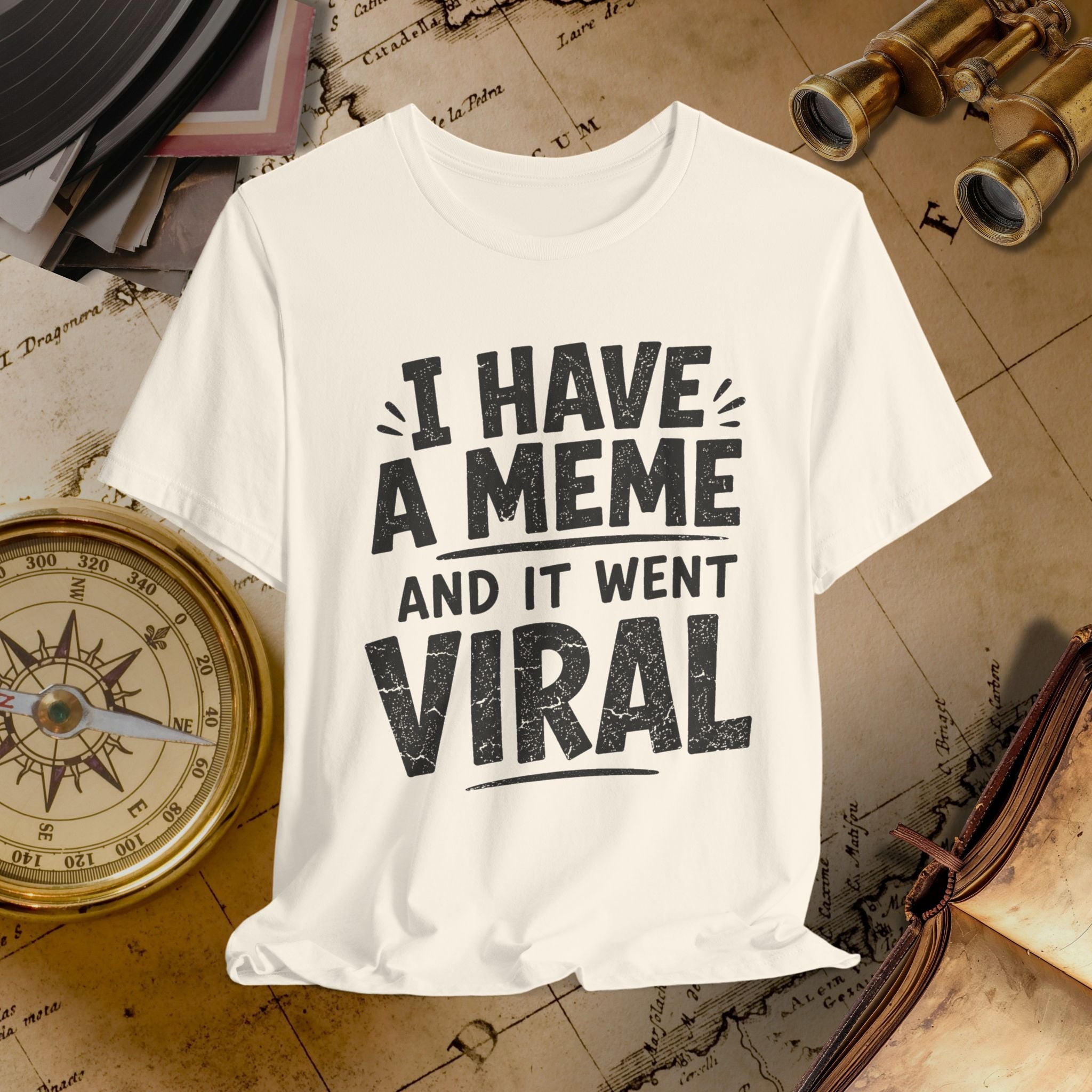 Beige t-shirt with 'I have a meme and it went viral' text on a vintage map background