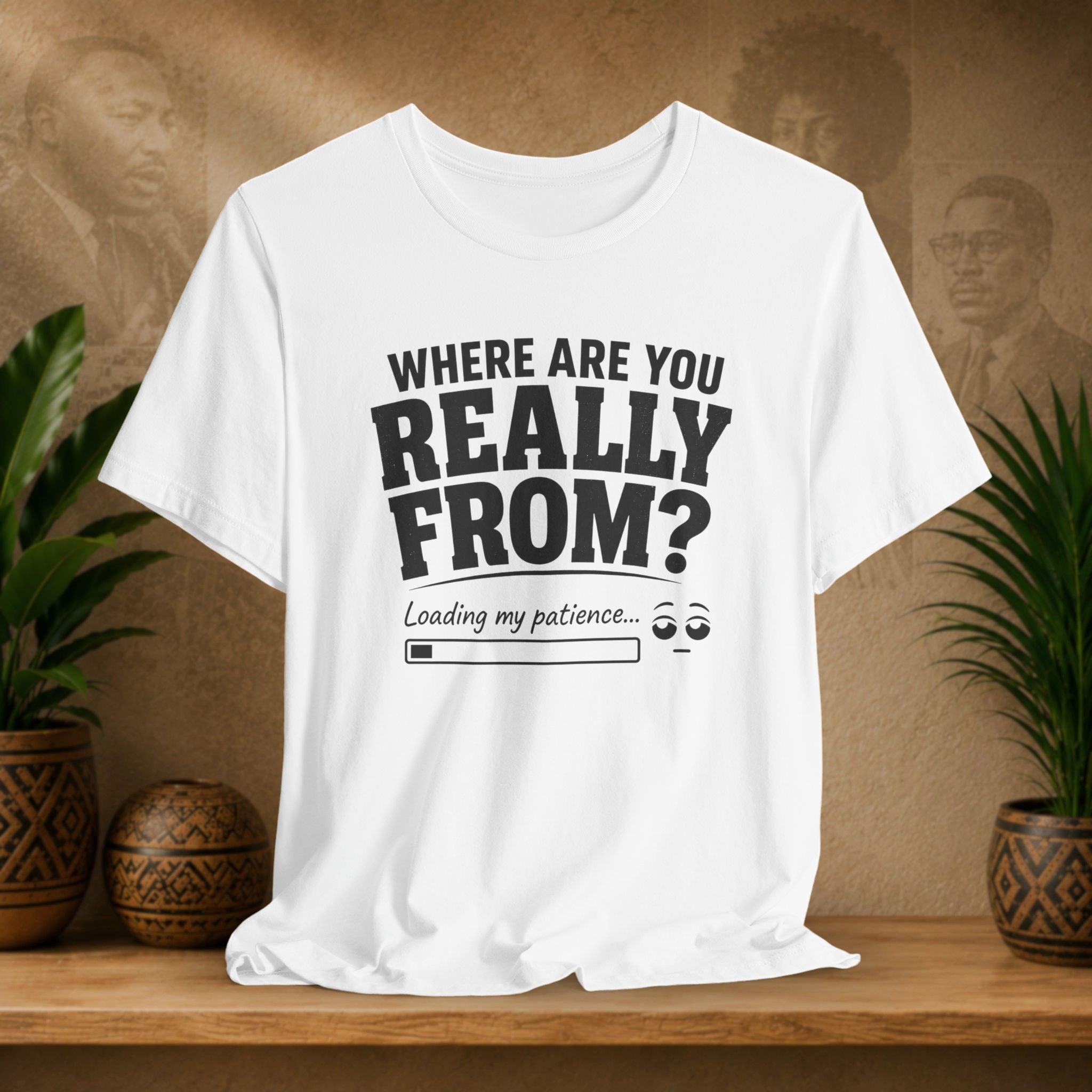 White t-shirt with humorous text design on a wooden surface with plants and a textured wall background