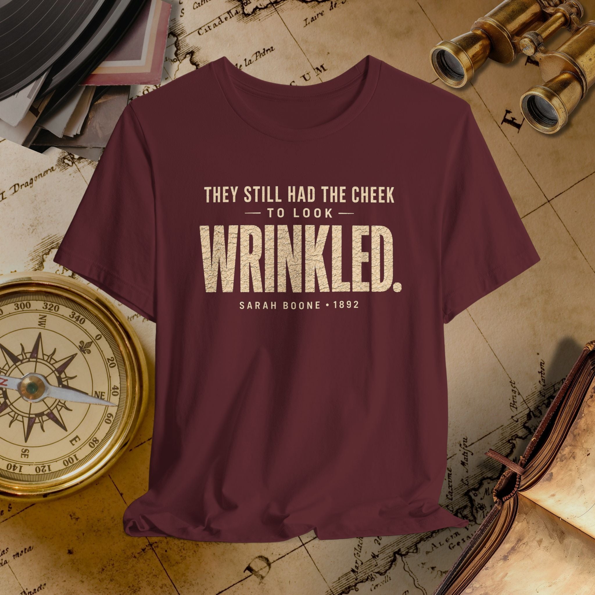 Maroon t-shirt with humorous quote on vintage map background