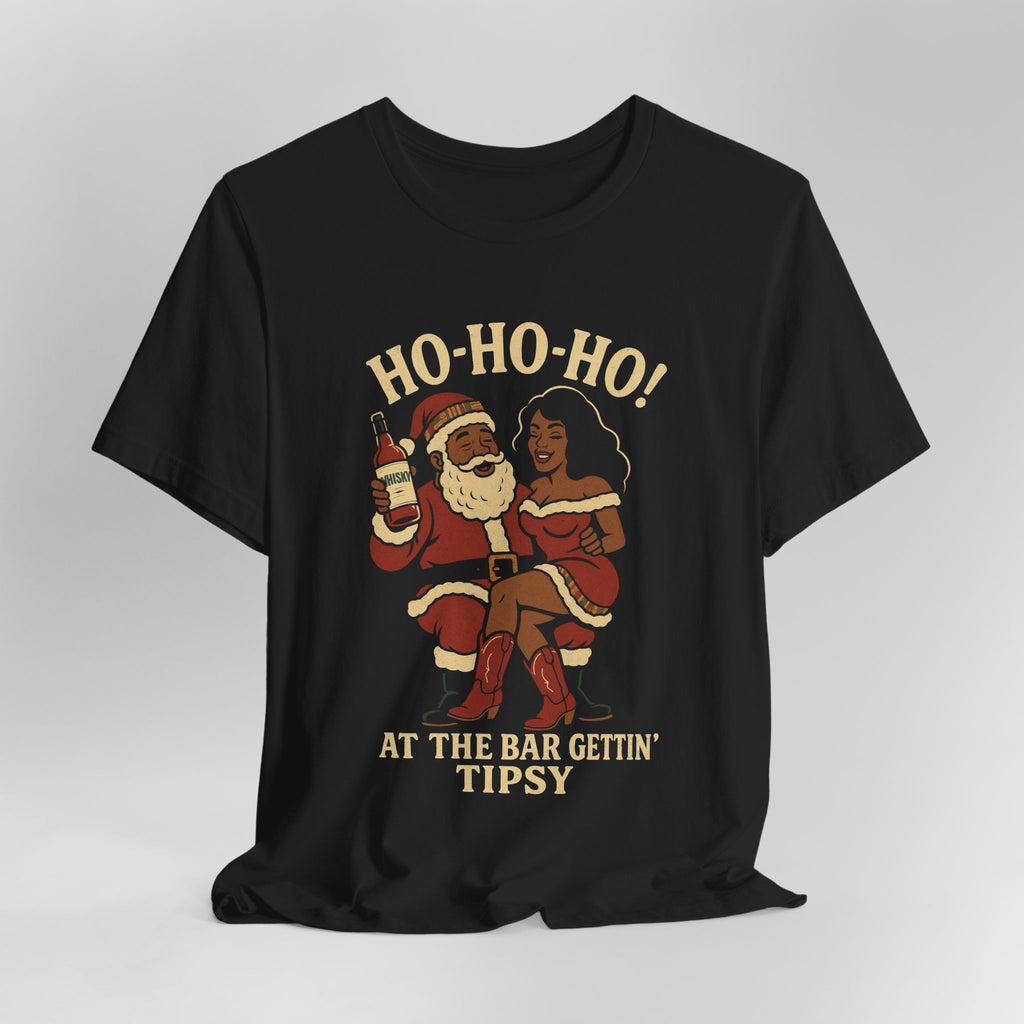 Black t-shirt with a graphic of Santa Claus and a woman, text 'HO-HO-HO! AT THE BAR GETTIN' TIPSY', on a light gray background.