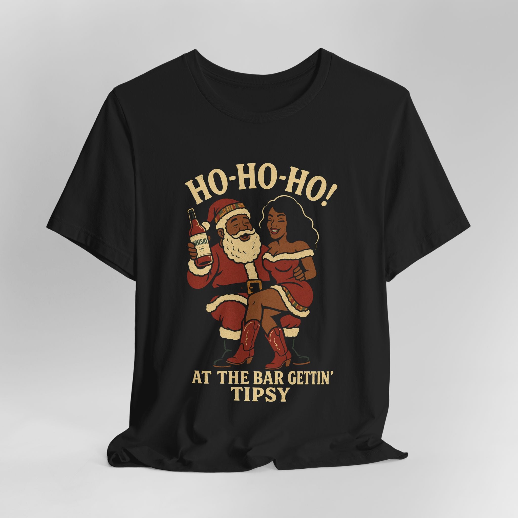 Black t-shirt with a graphic of Santa Claus and a woman, text 'HO-HO-HO! AT THE BAR GETTIN' TIPSY', on a light gray background.