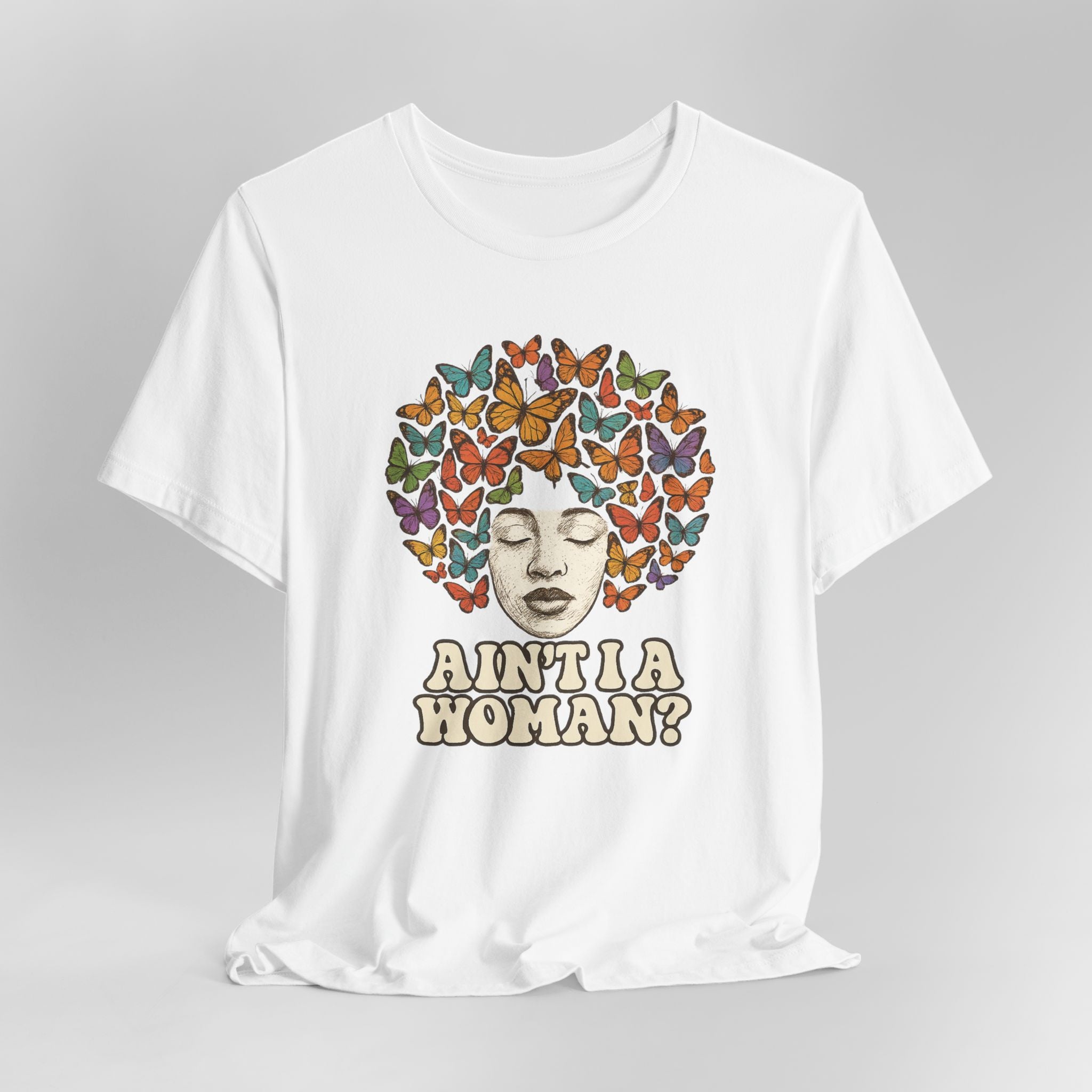 White t-shirt with a colorful butterfly design and text on a gray background
