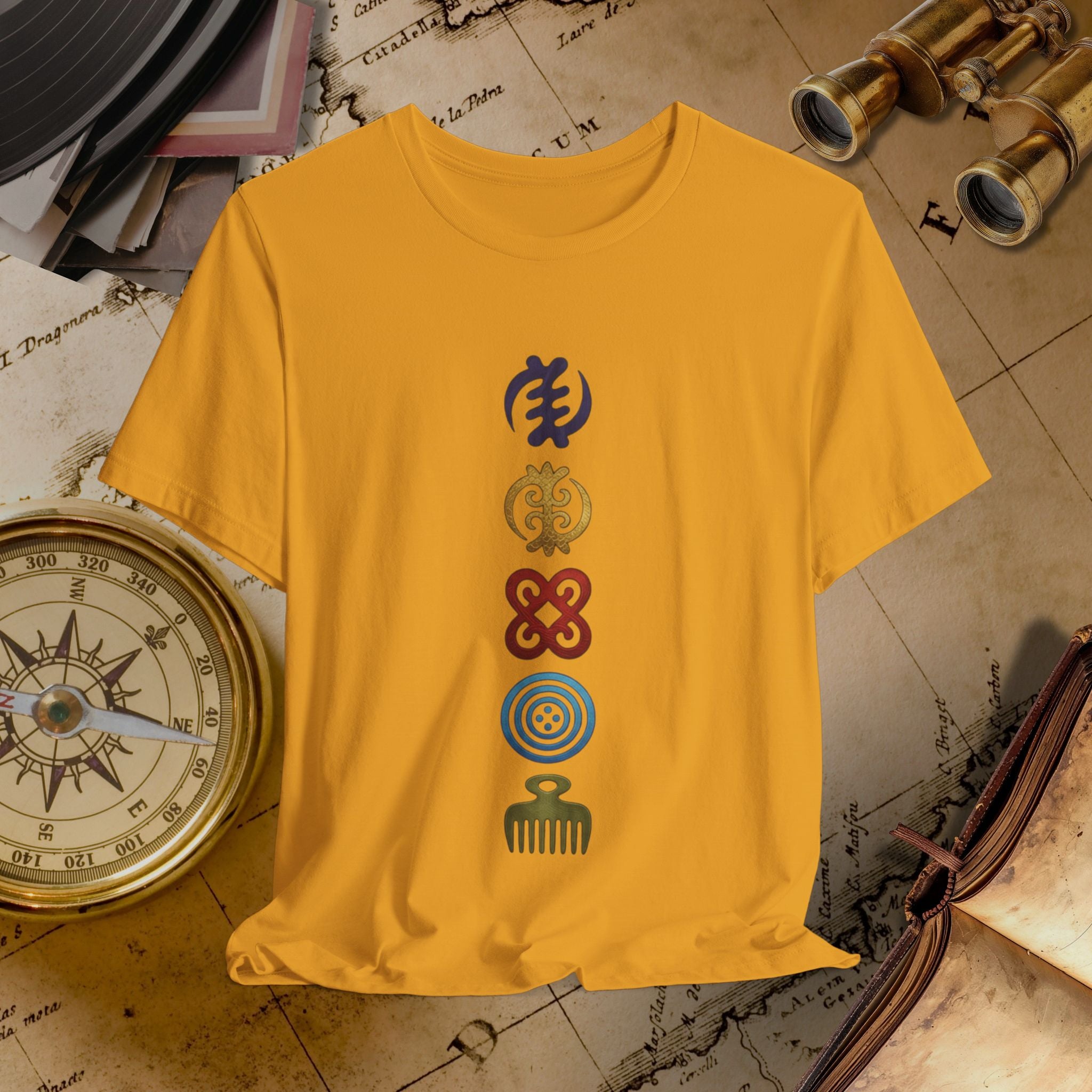 Mustard t-shirt with four colorful symbols on a vintage map background