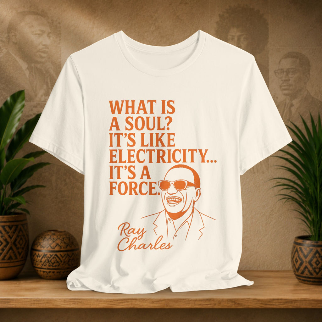 Beige t-shirt with Ray Charles quote on a wooden shelf with plants and decorative items.