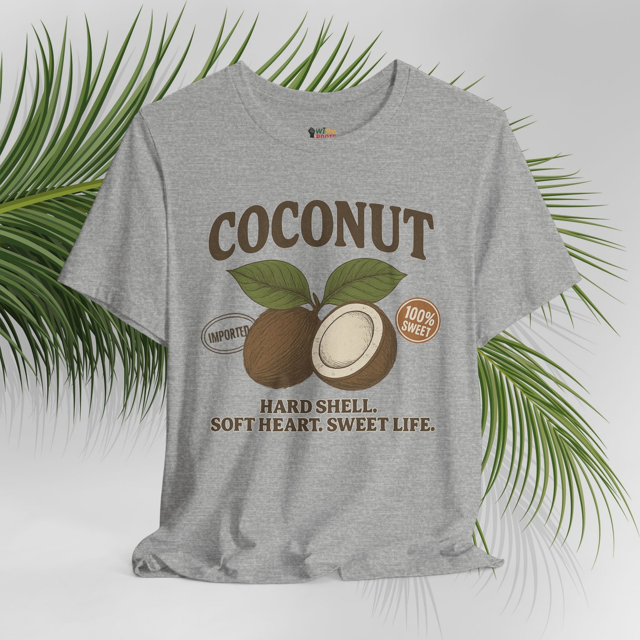Gray t-shirt with coconut graphic and text on a white background with green leaves.