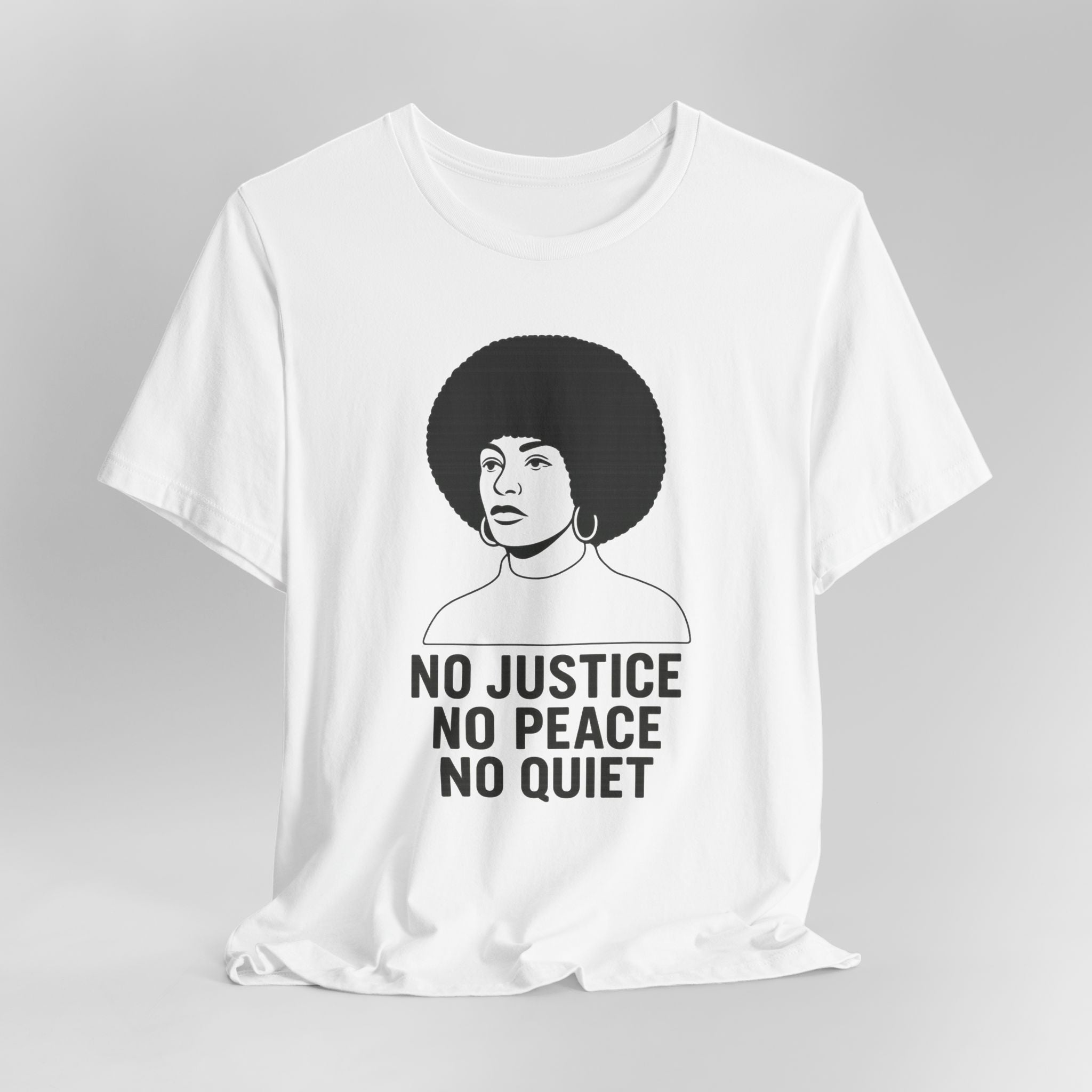 White t-shirt with a graphic of a woman with an afro and text 'No Justice No Peace No Quiet' on a gray background