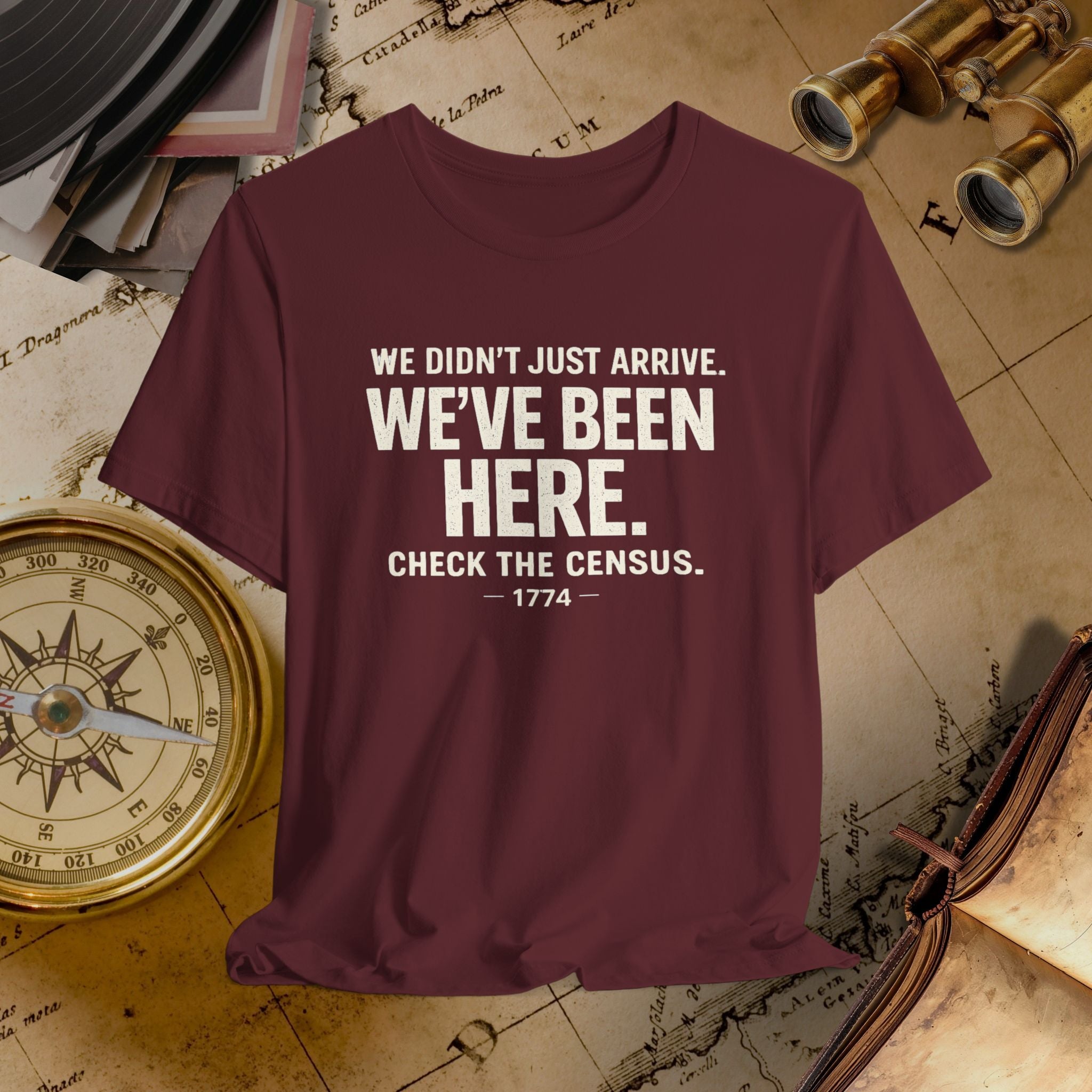 Maroon t-shirt with humorous text on a vintage map background