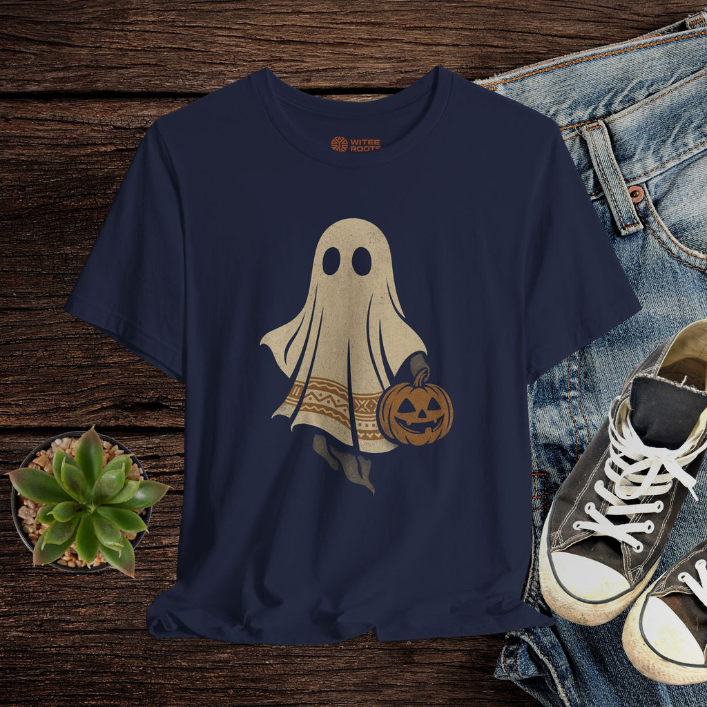Navy blue t-shirt with ghost and pumpkin design on a wooden surface with jeans and sneakers.