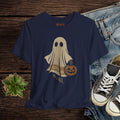 Navy blue t-shirt with ghost and pumpkin design on a wooden surface with jeans and sneakers.