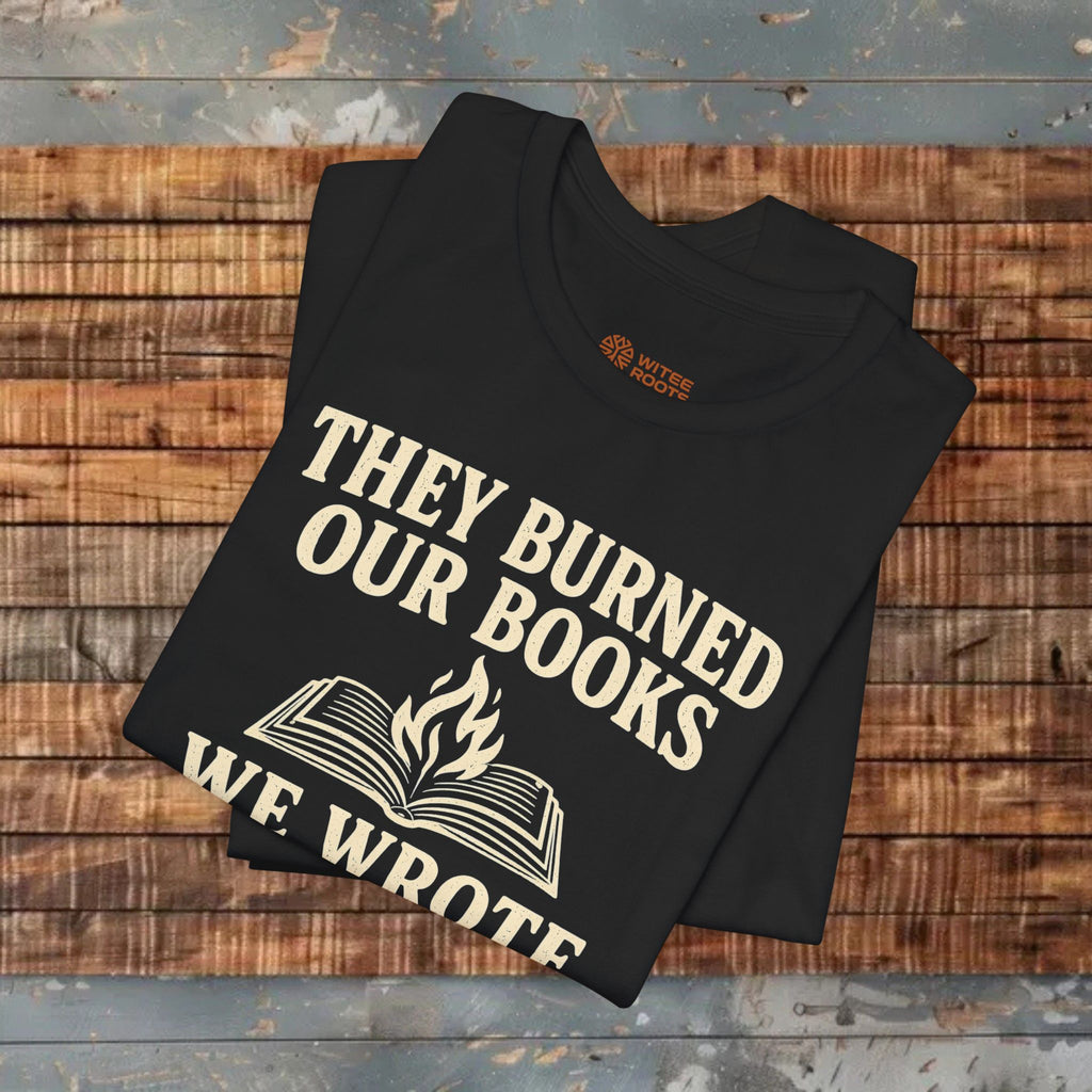 Black t-shirt with white text and graphic on a wooden surface